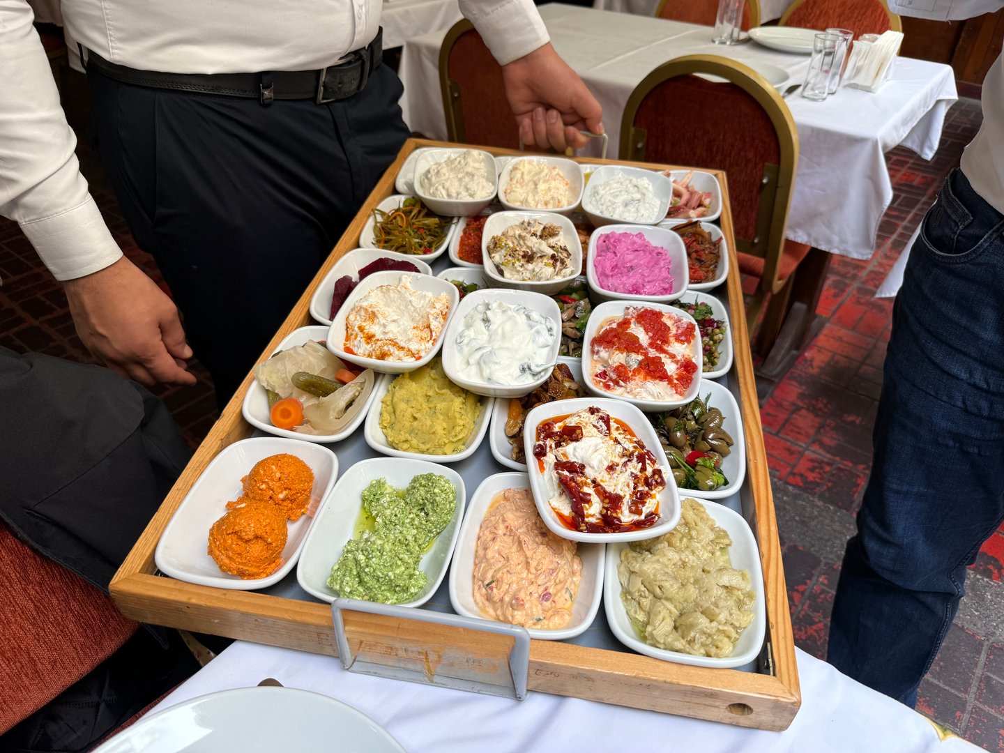 Meze of Luxury table with plate of fish, meat, pickles, antipasto, aubergine, appetizers, cheese, mezze, salad, octopus, raki and ouzo. Ready to serve