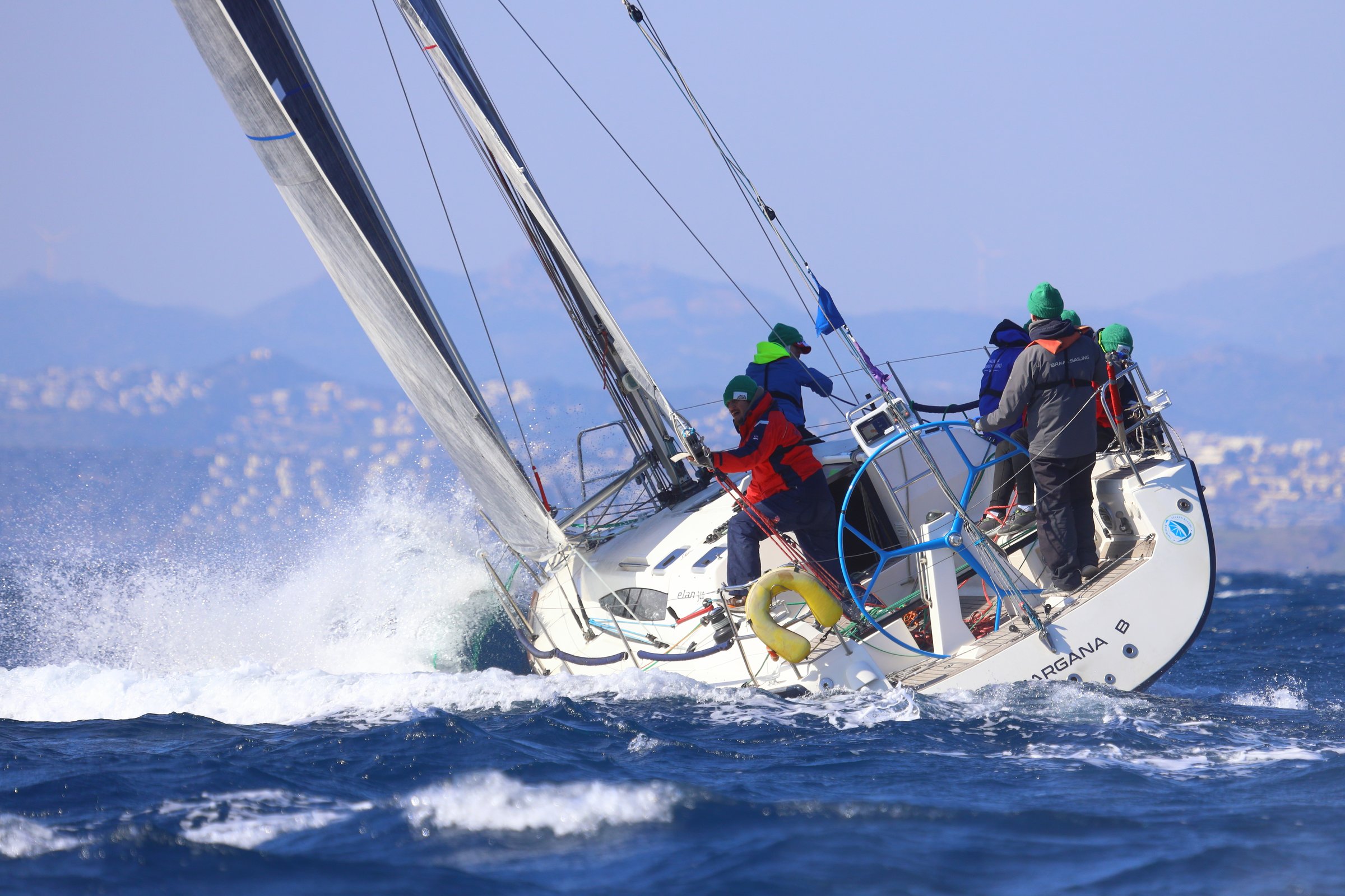 Bodrum, Türkiye. February 03, 2024: Sailboats sail in the blue waters of the Aegean Sea in windy weather on the coast of the famous holiday resort of Bodrum. Boat owners have a pleasant weekend with their sails in the town, where the winter months are warm.
