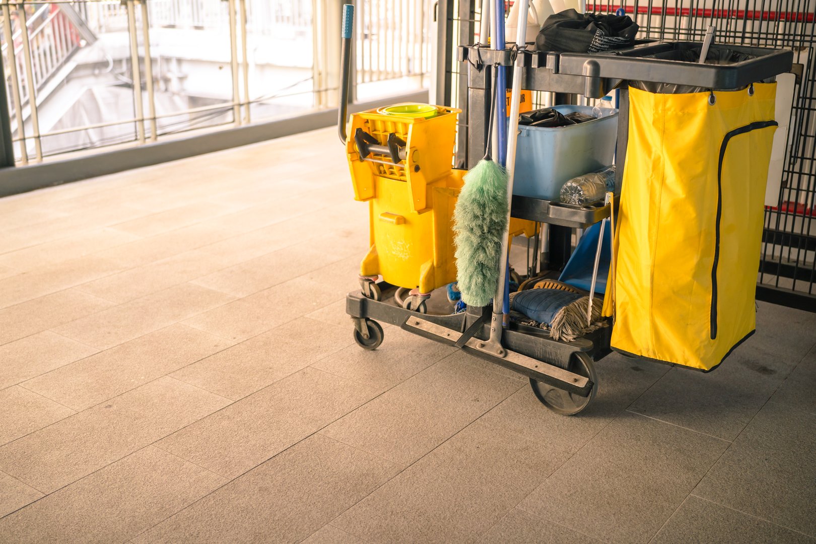 Cleaning tools cart in public walk way. Bucket and set of cleaning equipment. Concept of service, worker and equipment for cleaner and health.