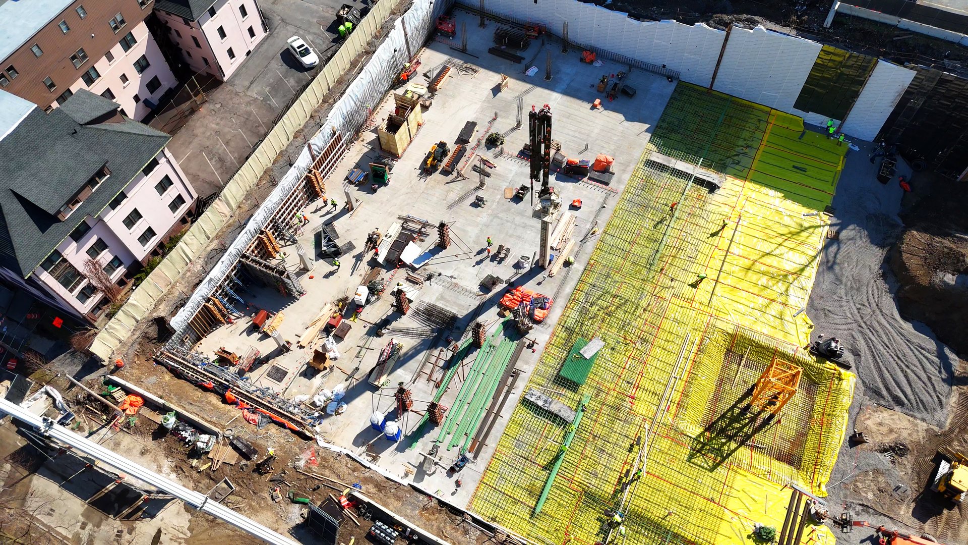 A site in which construction is being conducted and coordinated for the purpose of building a new development for student housing as workers on the ground continue to build the residences of people that build the future