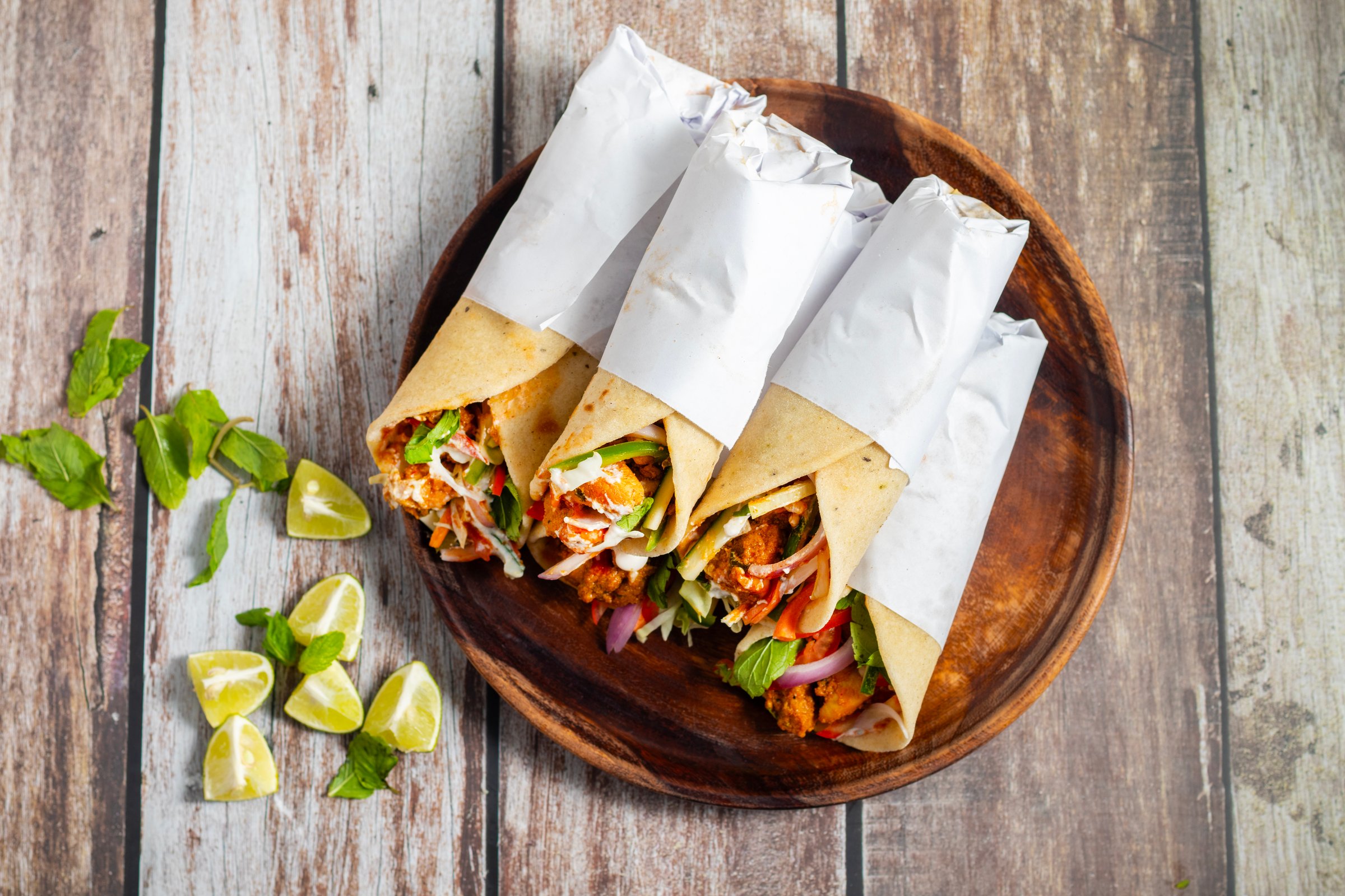 Chicken shawarma roll is a Middle Eastern wrap made with spiced grilled chicken, garlic sauce, pickled veggies, and flatbread, served warm and flavorful.