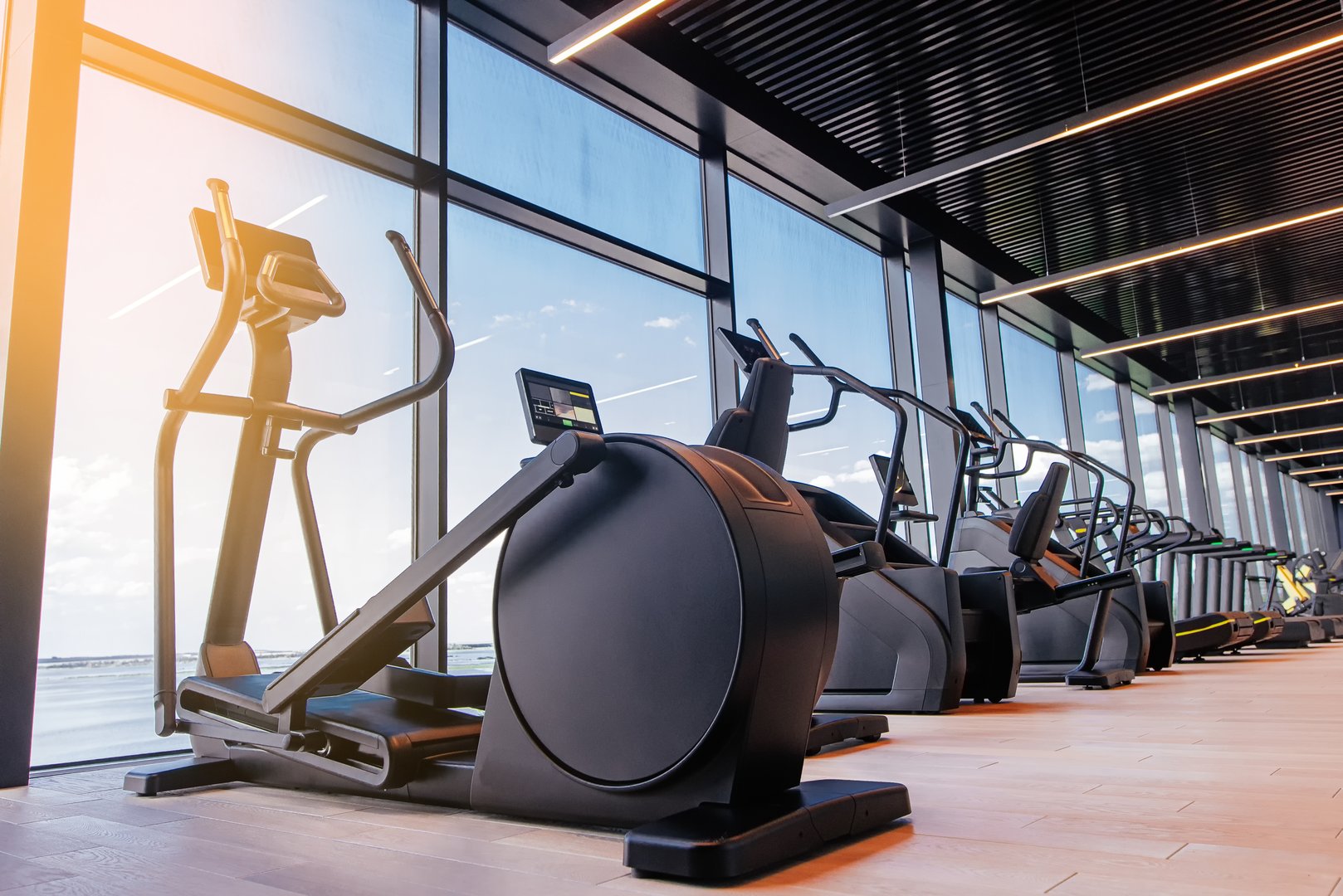 Modern light gym. Sports equipment in gym. Elliptical trainer