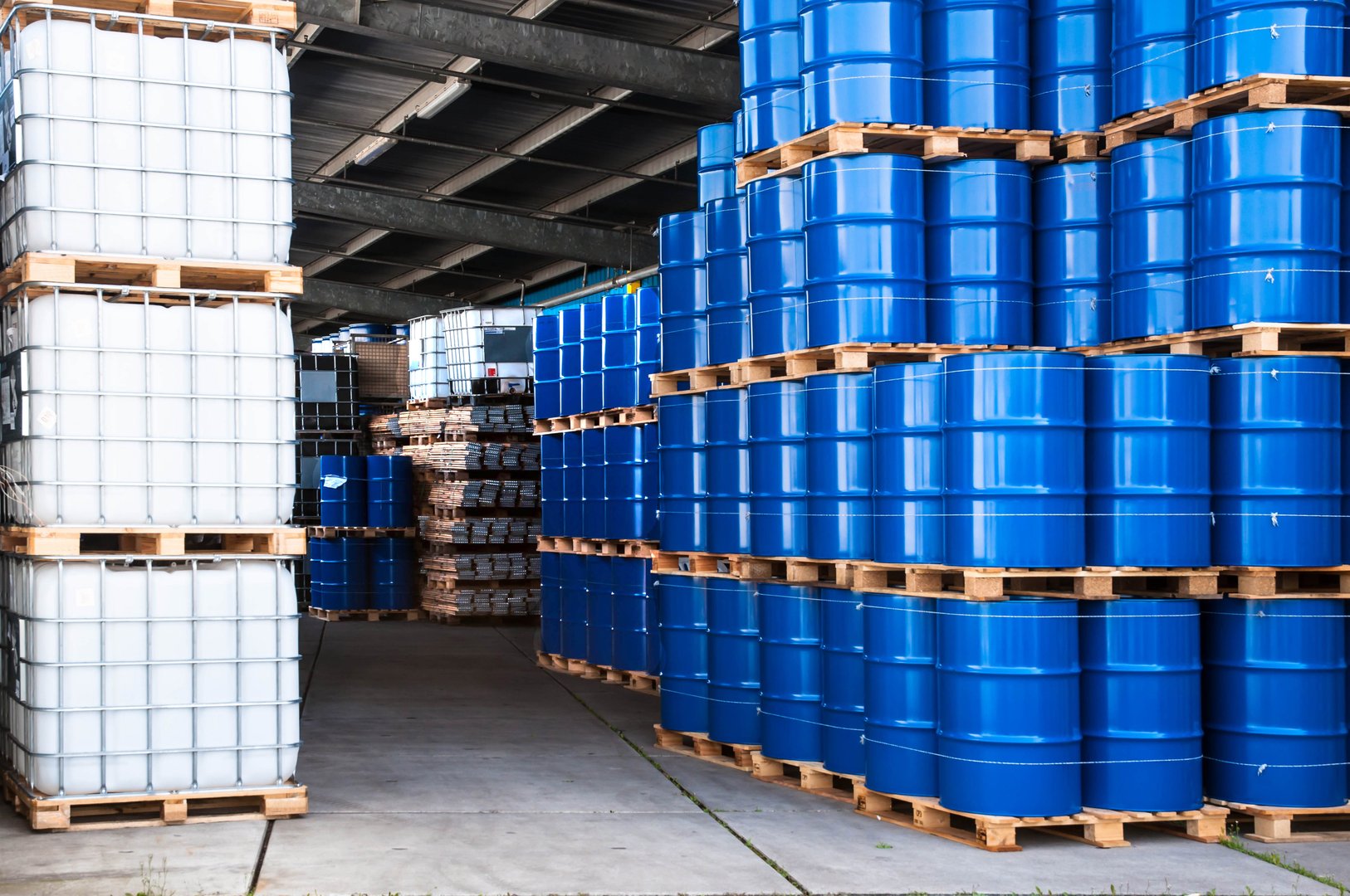 Blue drums and IBC container in a storage room