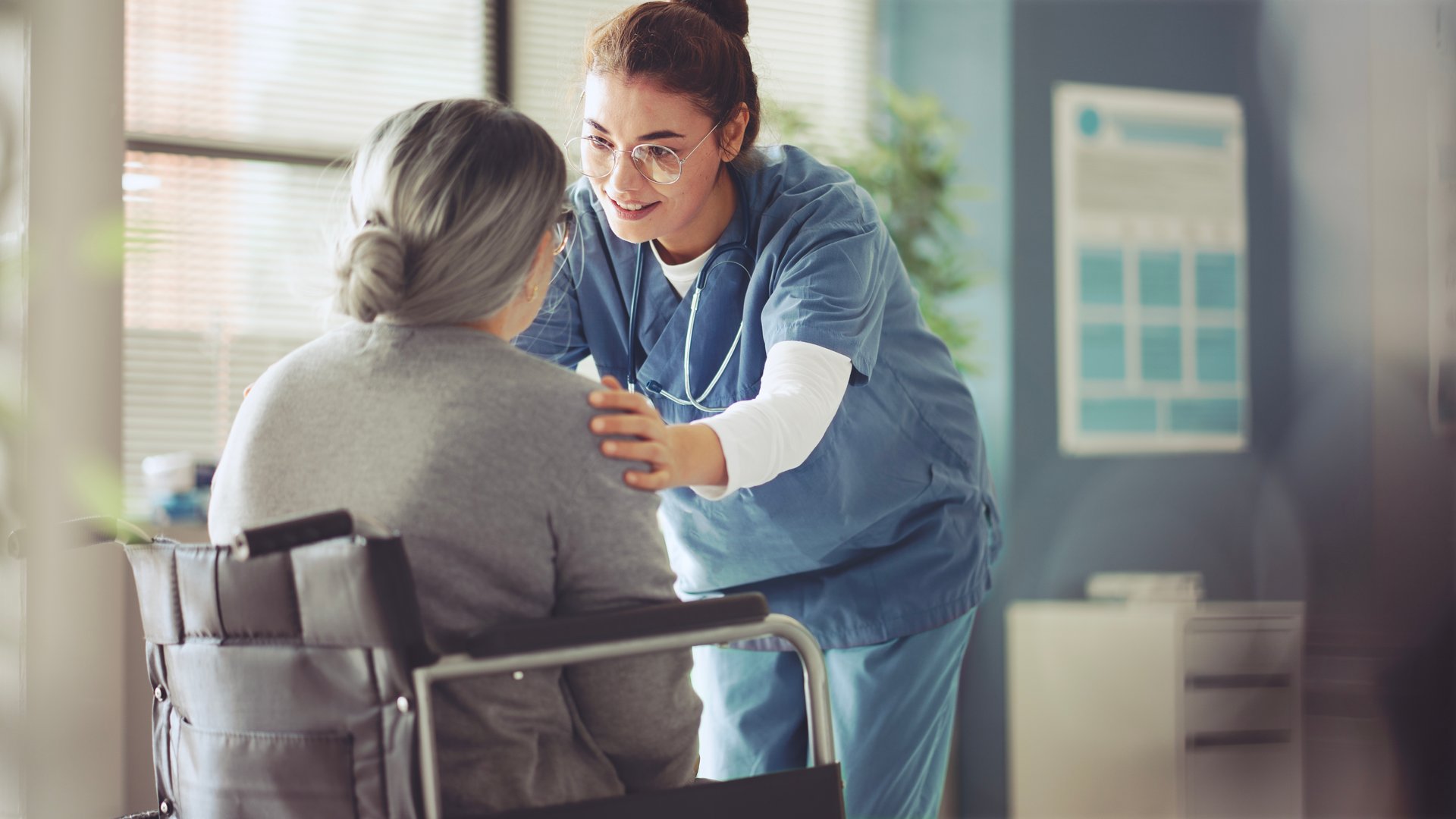 Senior woman in a wheelchair being cared for a nurse