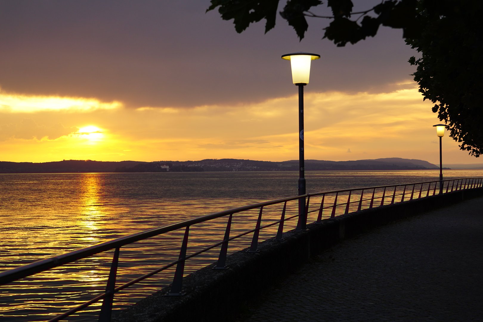 Sunset on the embankment. A walk along the boardwalk at sunset.