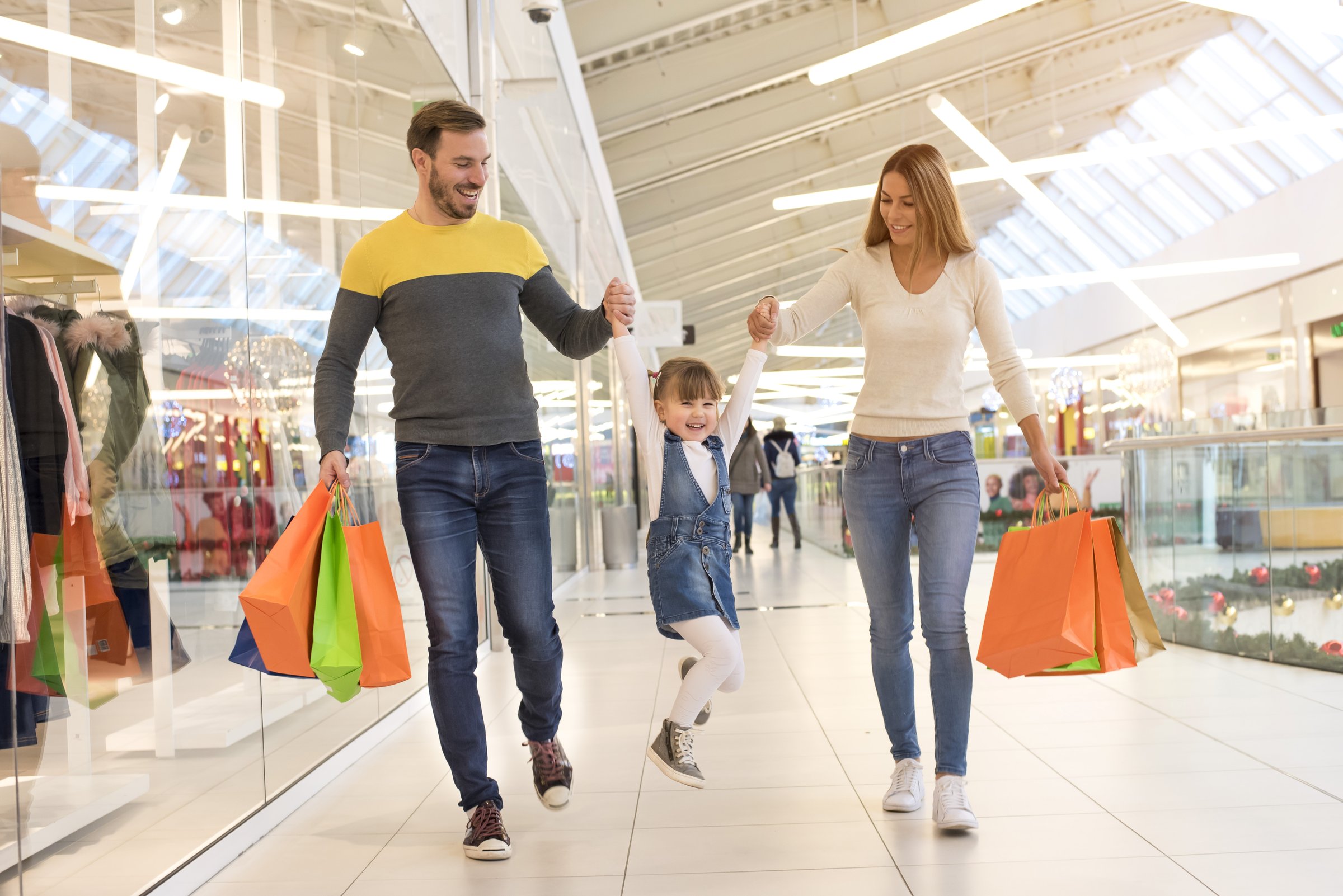 A shallow focus shot of a happy Caucasian family shopping in a mall