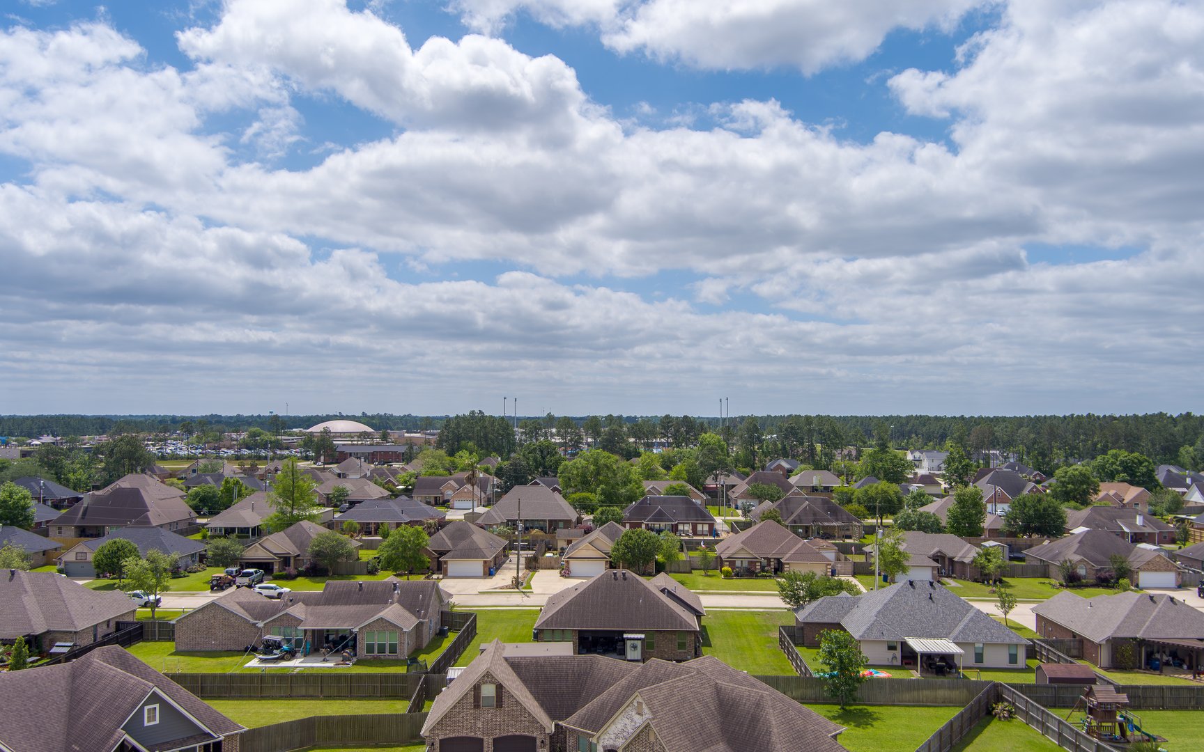 Aerial view of a neighborhood in Lumberton Texas with a overcast sky in late Springtime.