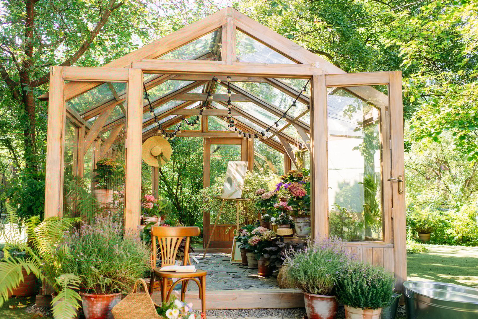 Wood and glass greenhouse, plants and nature with home gardening. Flowers and greens, with botanical or agriculture in the garden. exterior