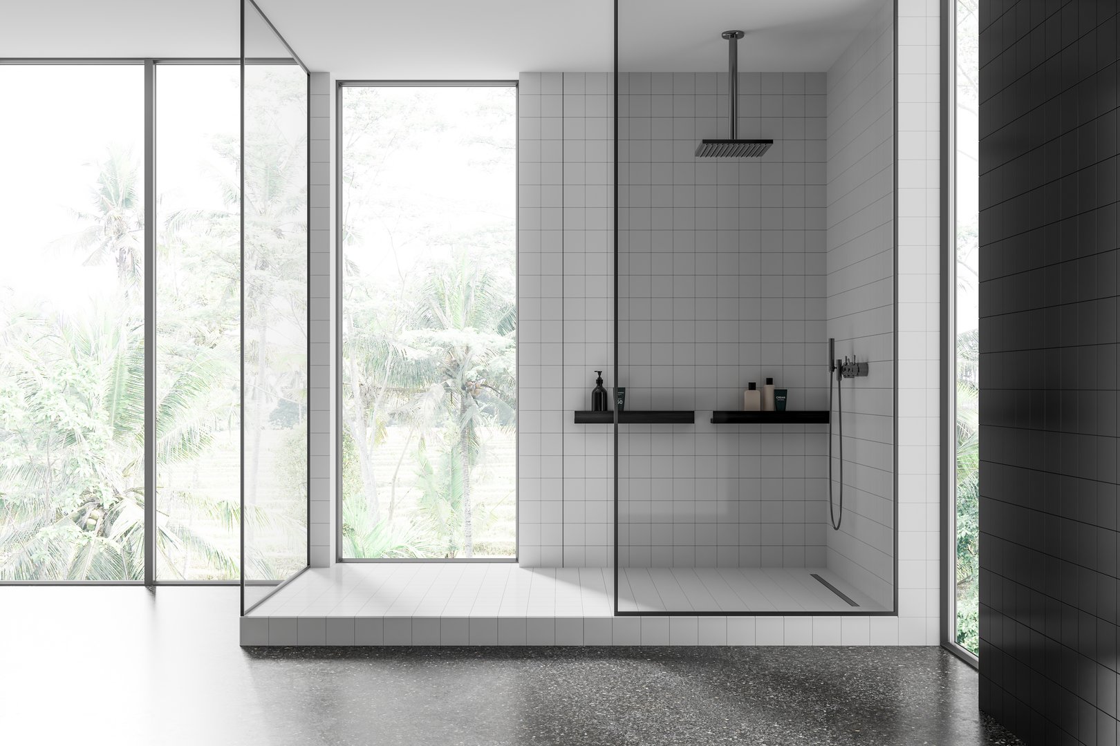 Spacious white-tiled shower with glass walls, fixtures, tropical outdoor view through large windows, minimalist design concept.