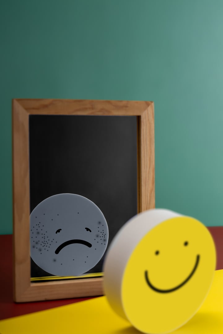 Mental Health Concept. Complexity of Deepest Mind and the Personality to Expressed Different Characteristics in Public. a Happy Face Reflects a Sad face on another side of the Mirror. Bipolar Disorder