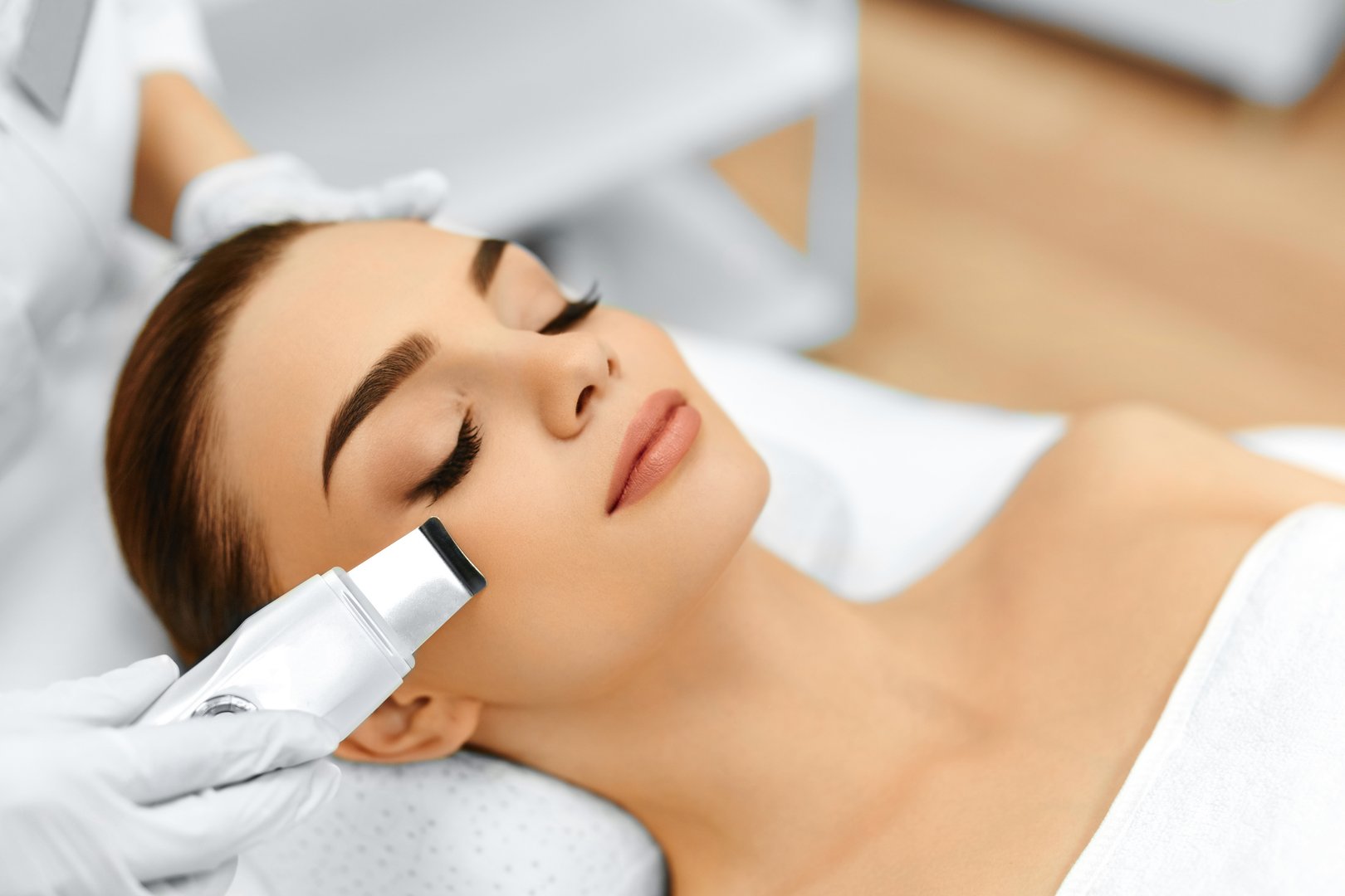 Skin Care. Close-up Of Beautiful Woman Receiving Ultrasound Cavitation Facial Peeling. Ultrasonic Skin Cleansing Procedure. Beauty Treatment. Cosmetology. Beauty Spa Salon.