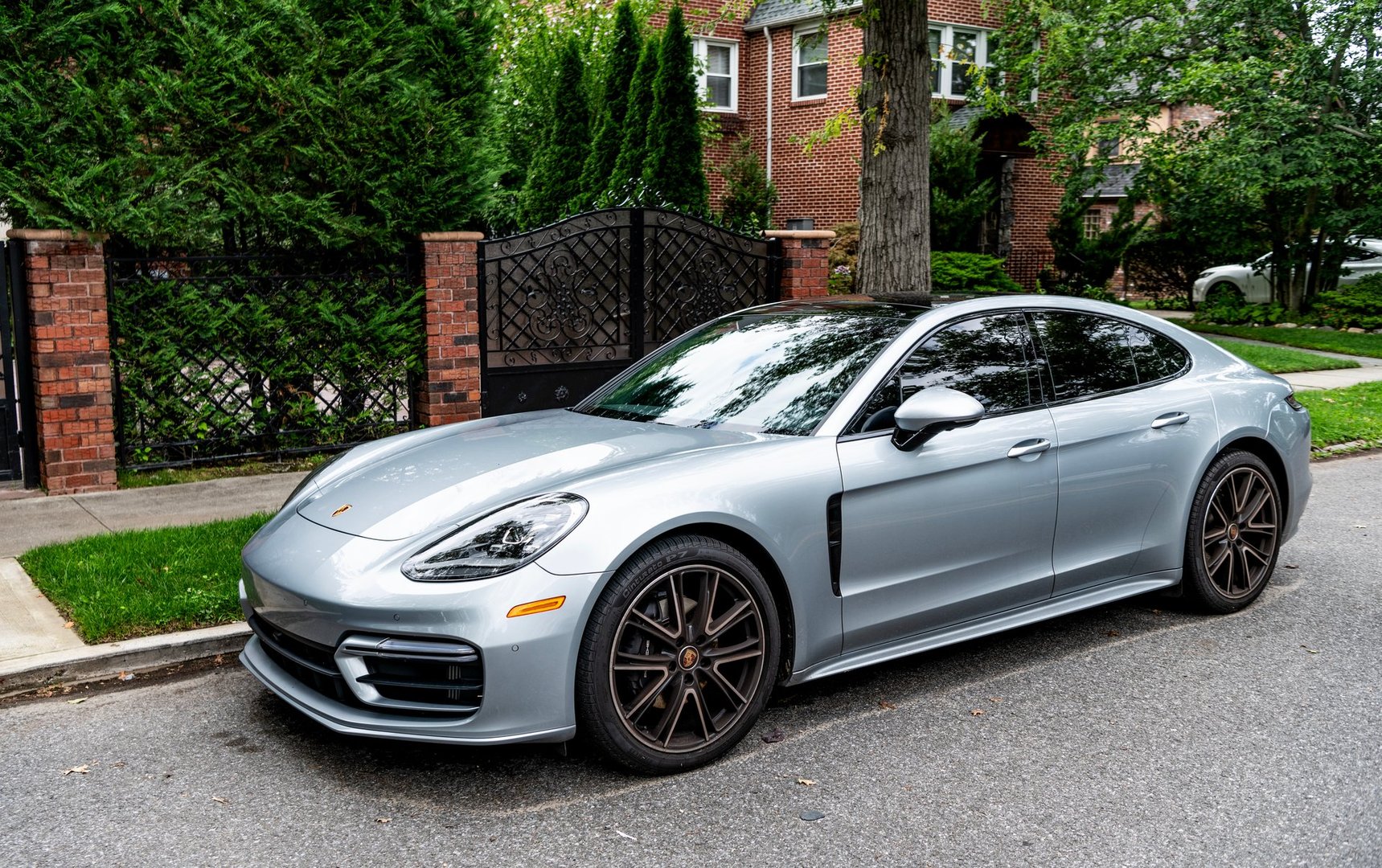 New York City, USA - August 26, 2023: Porsche Panamera sportscar vehicle silver color parked, side view.