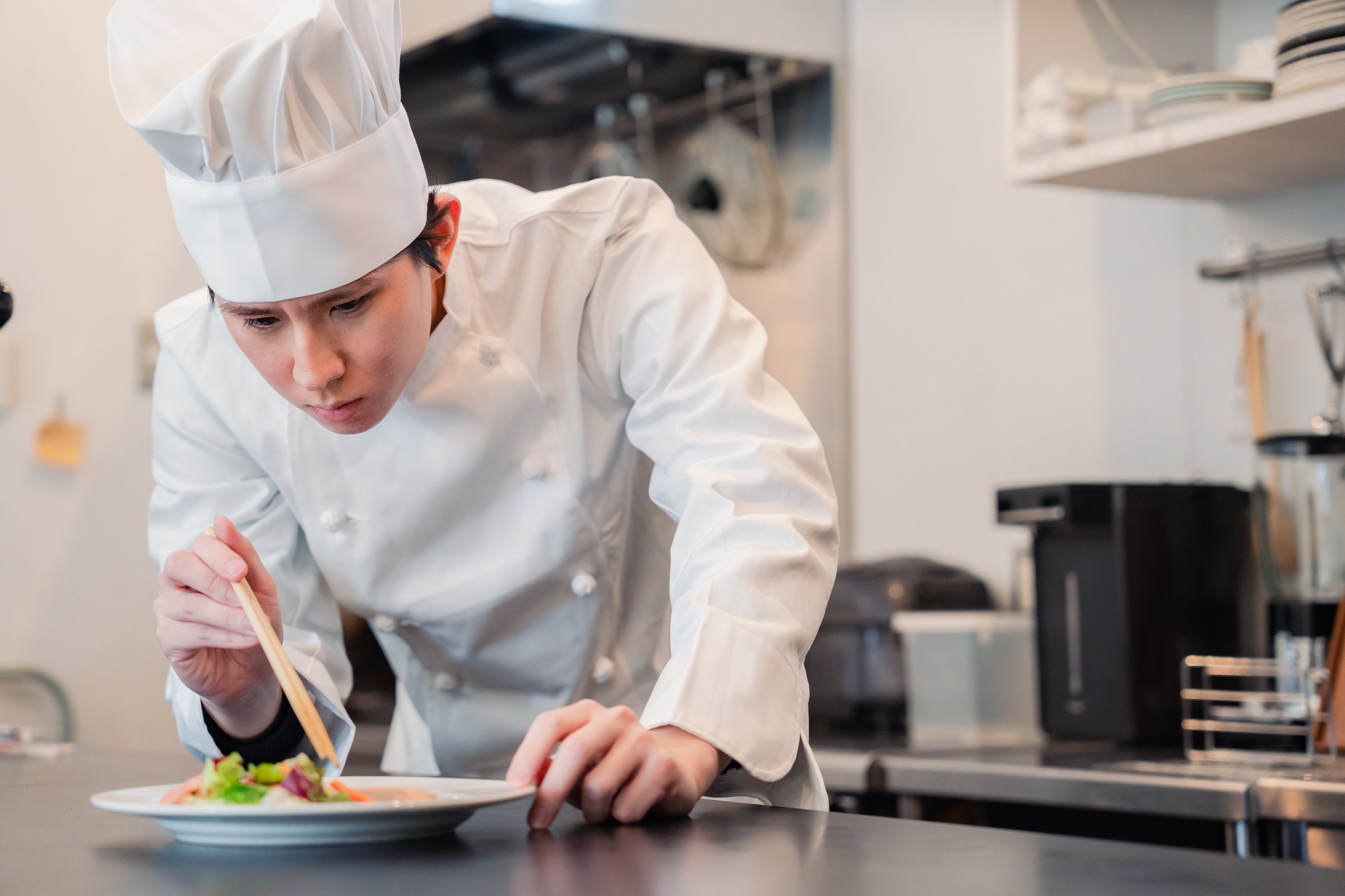 Chef preparing a dish in the kitchen