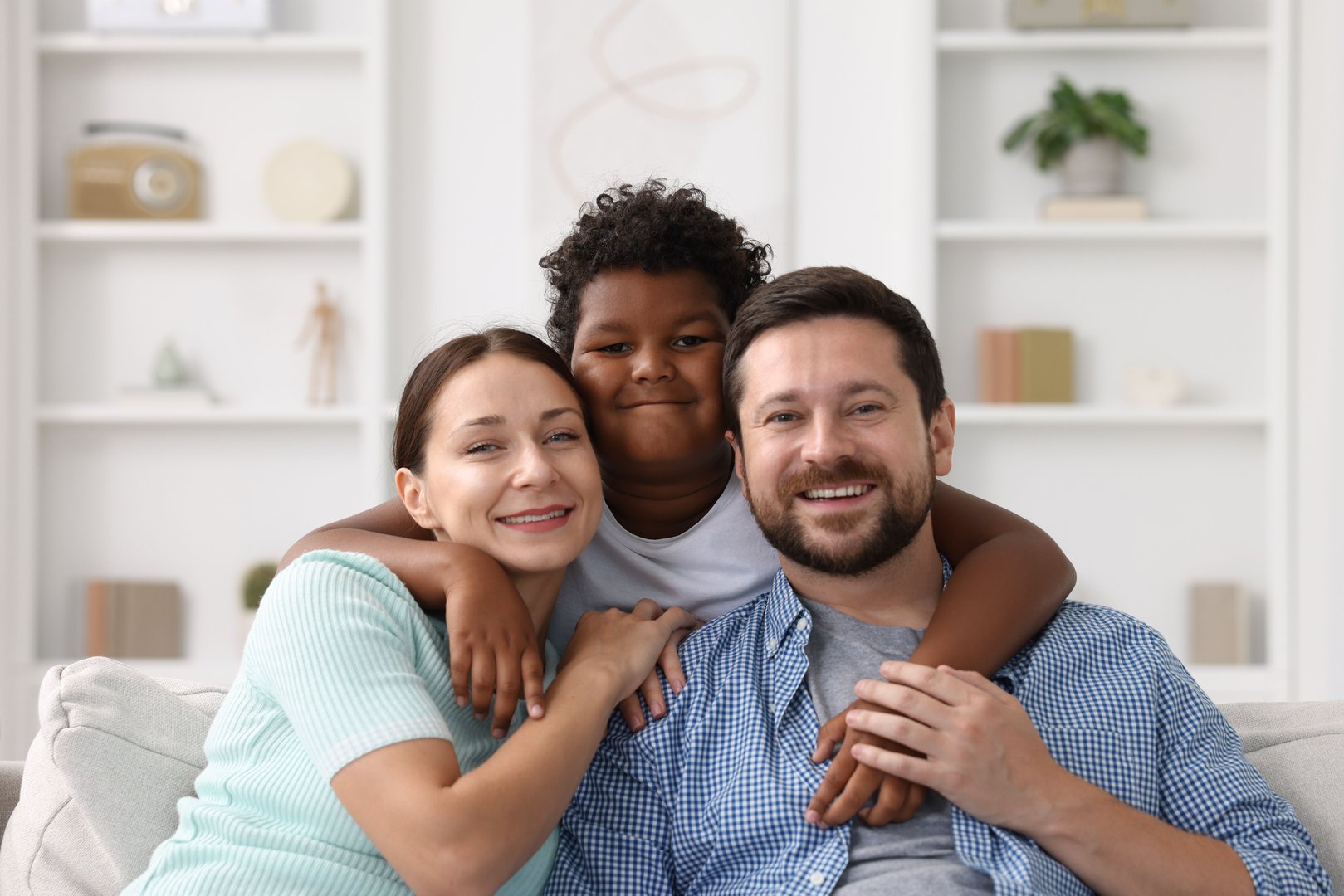 Happy parents and their son at home