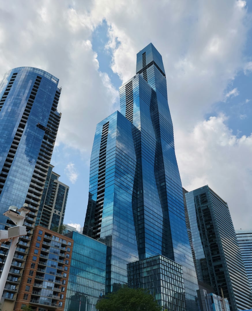A photograph of several Chicago skyscrapers taken from the Chicago River.