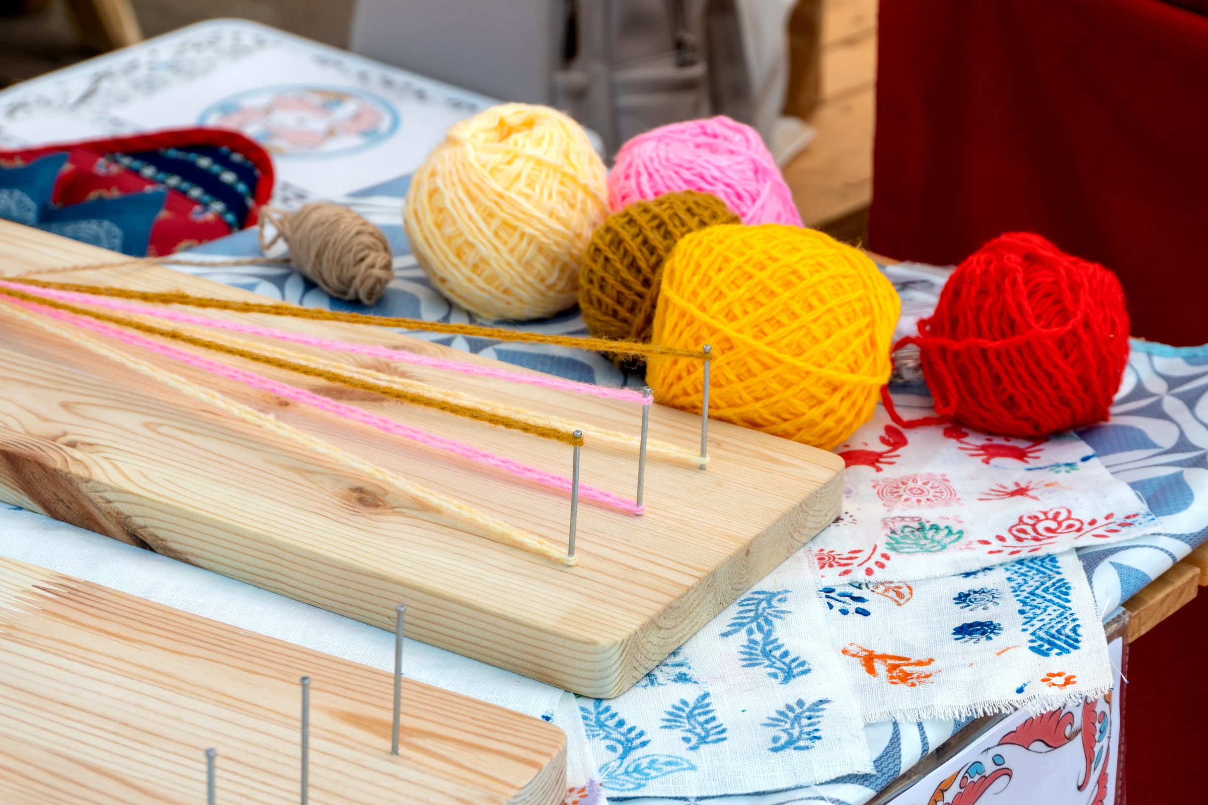 A device for weaving macrame from colored threads. A machine for weaving. Traditional folk crafts of Russia.