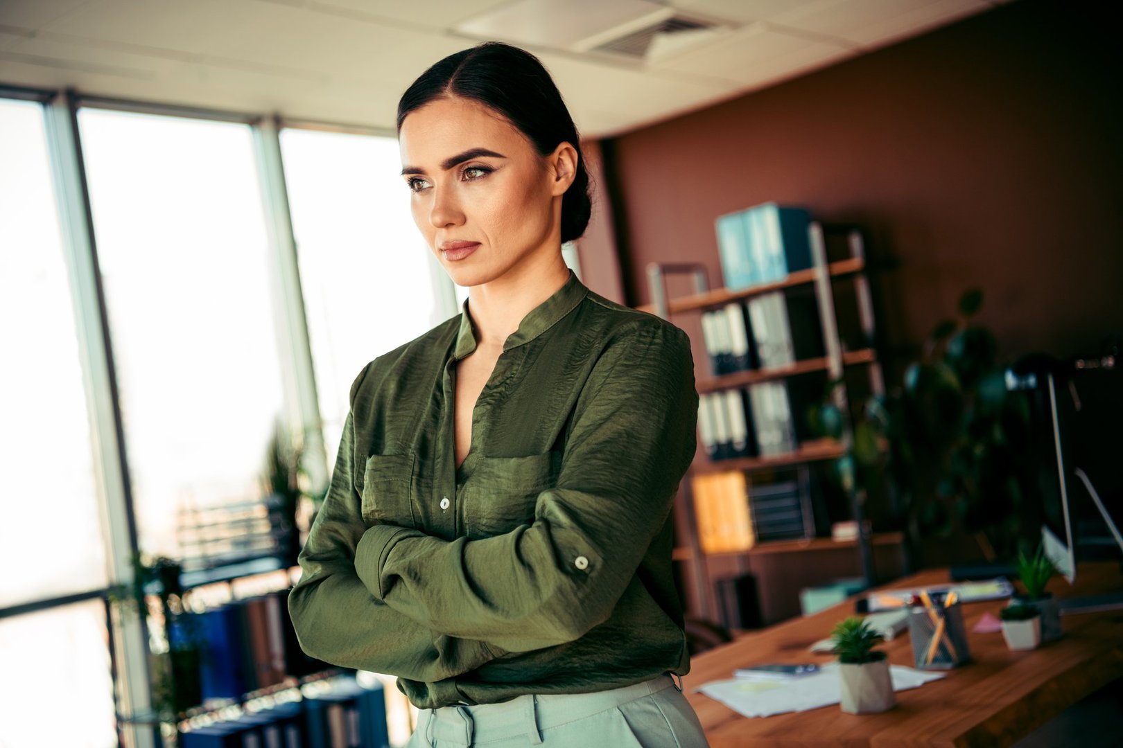 Confident modern businesswoman standing in her office, representing professionalism, determination, and business elegance.