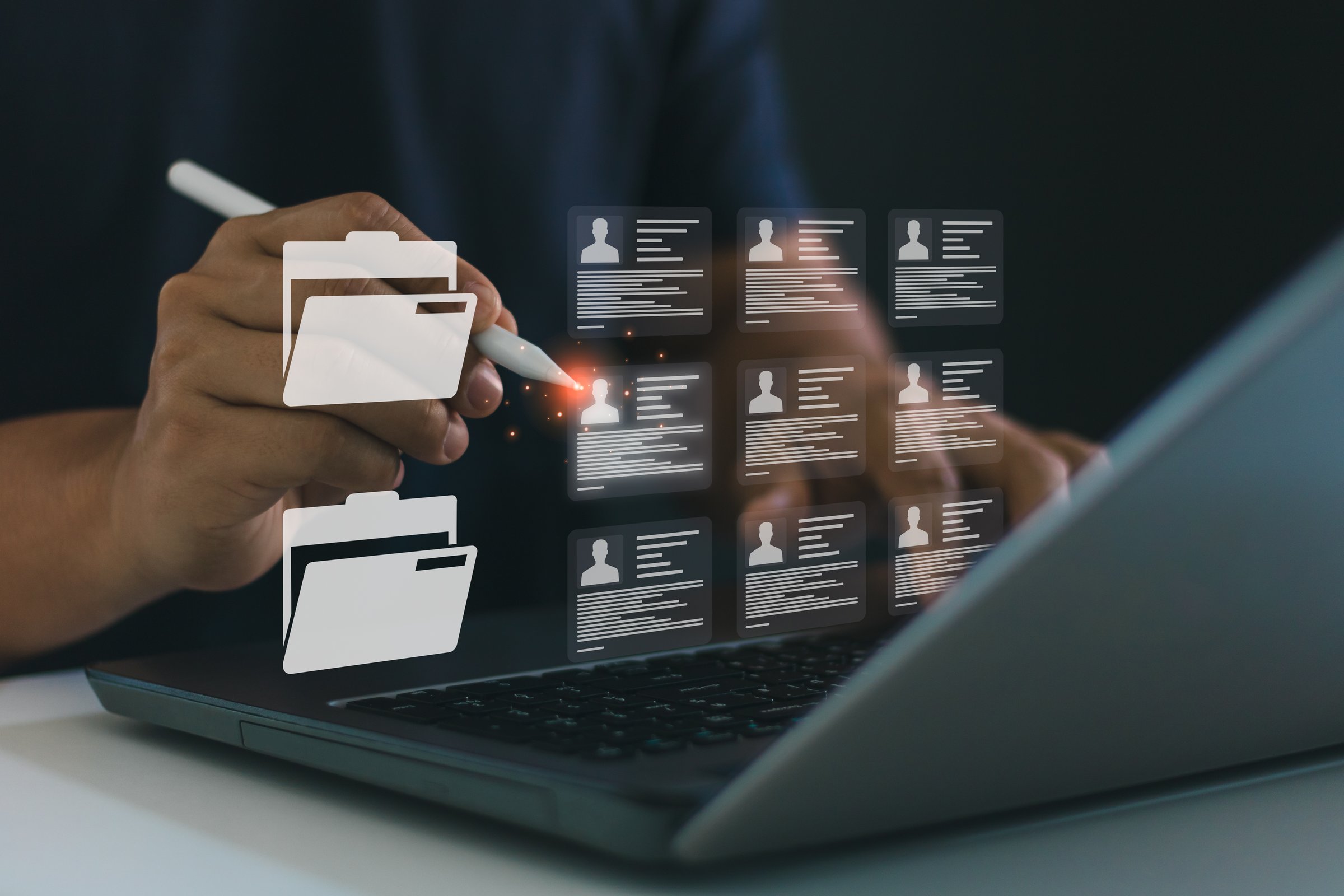 Business professional managing digital employee record using stylus and laptop. Digital file management system, online document access, cloud-based HR database solution, secure corporate information.