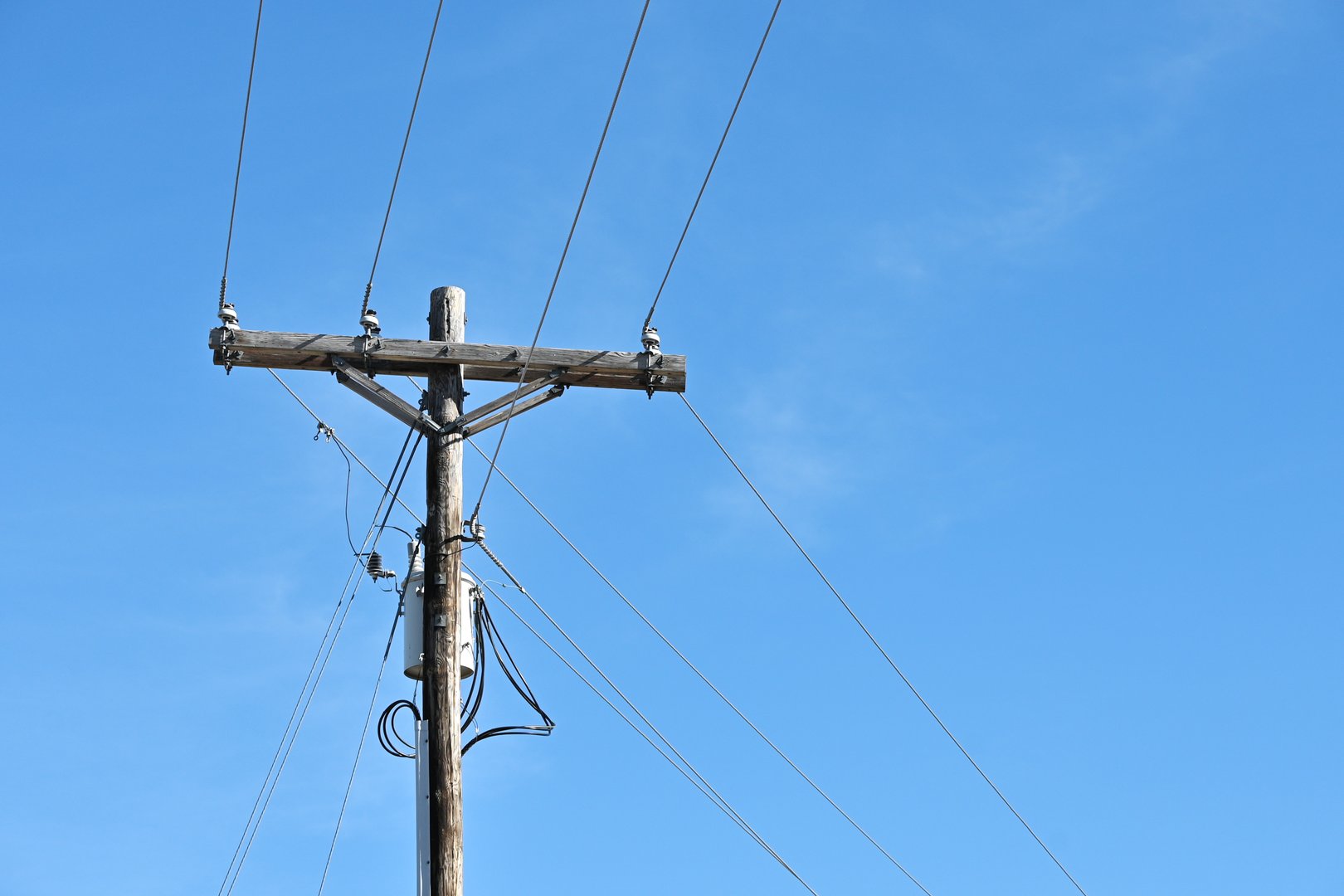Power wires turning a corner at the pole.