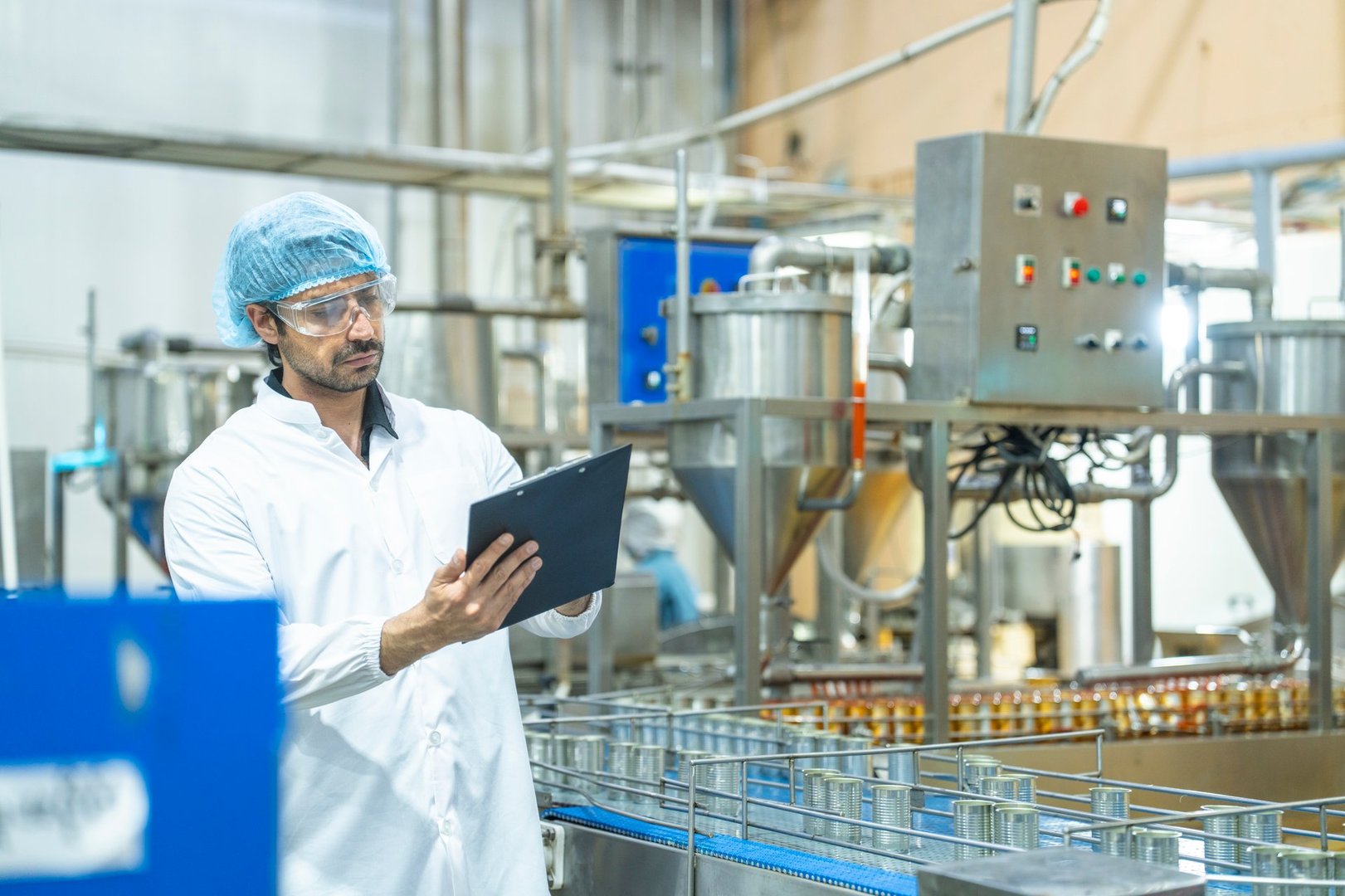 Factory technician in a clean uniform conducting a detailed inspection of a product, showcasing quality assurance, attention to detail, and adherence to safety and manufacturing standards.