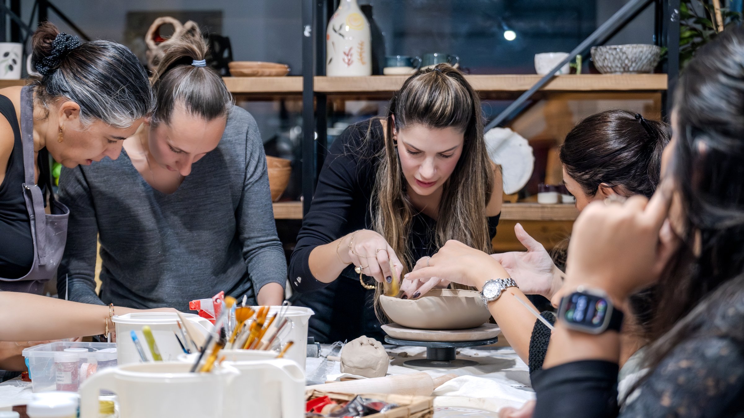 A clay-shaping art event held in an art studio with a group of people
