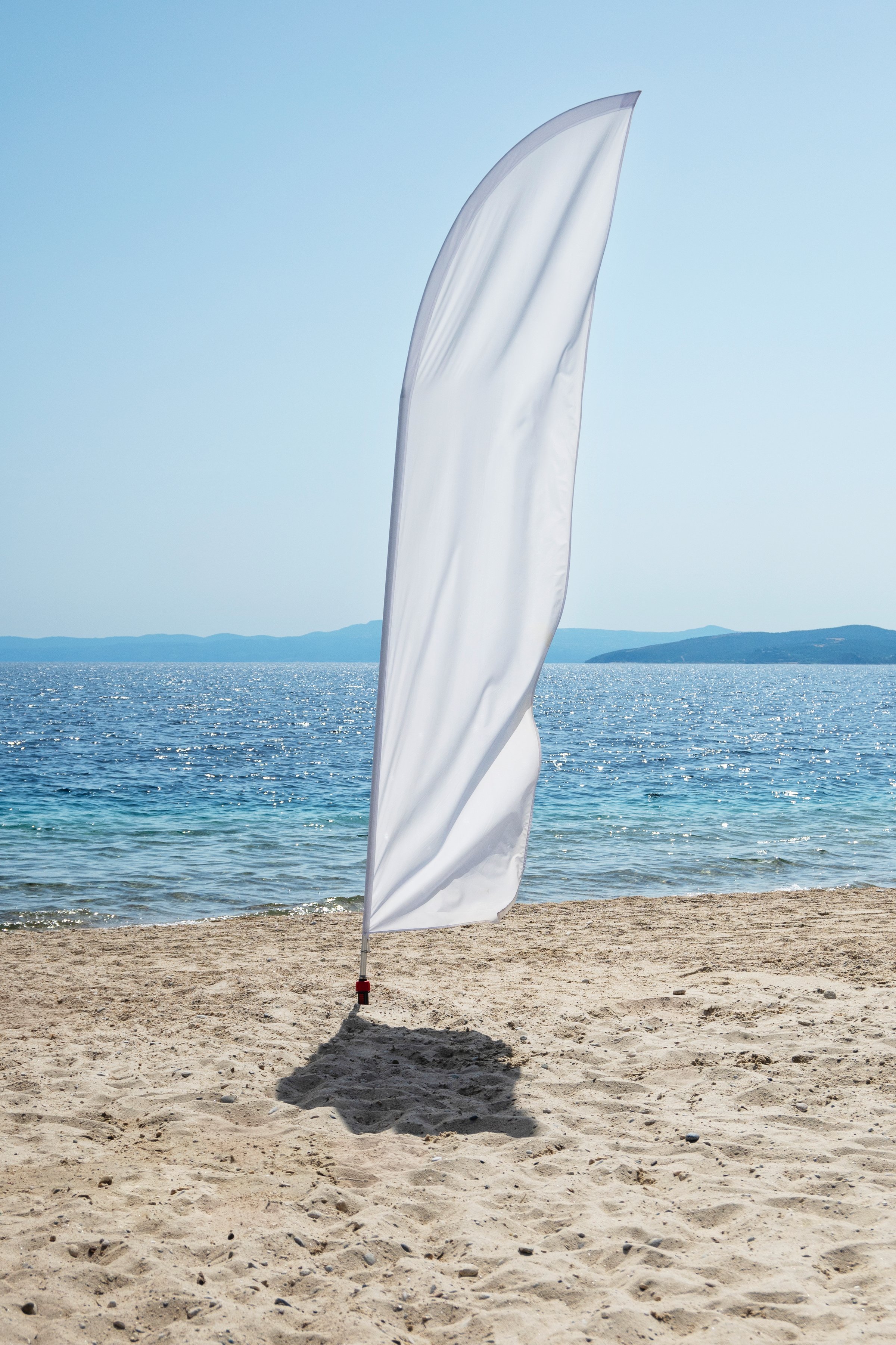 blank white flag on beach for advertising