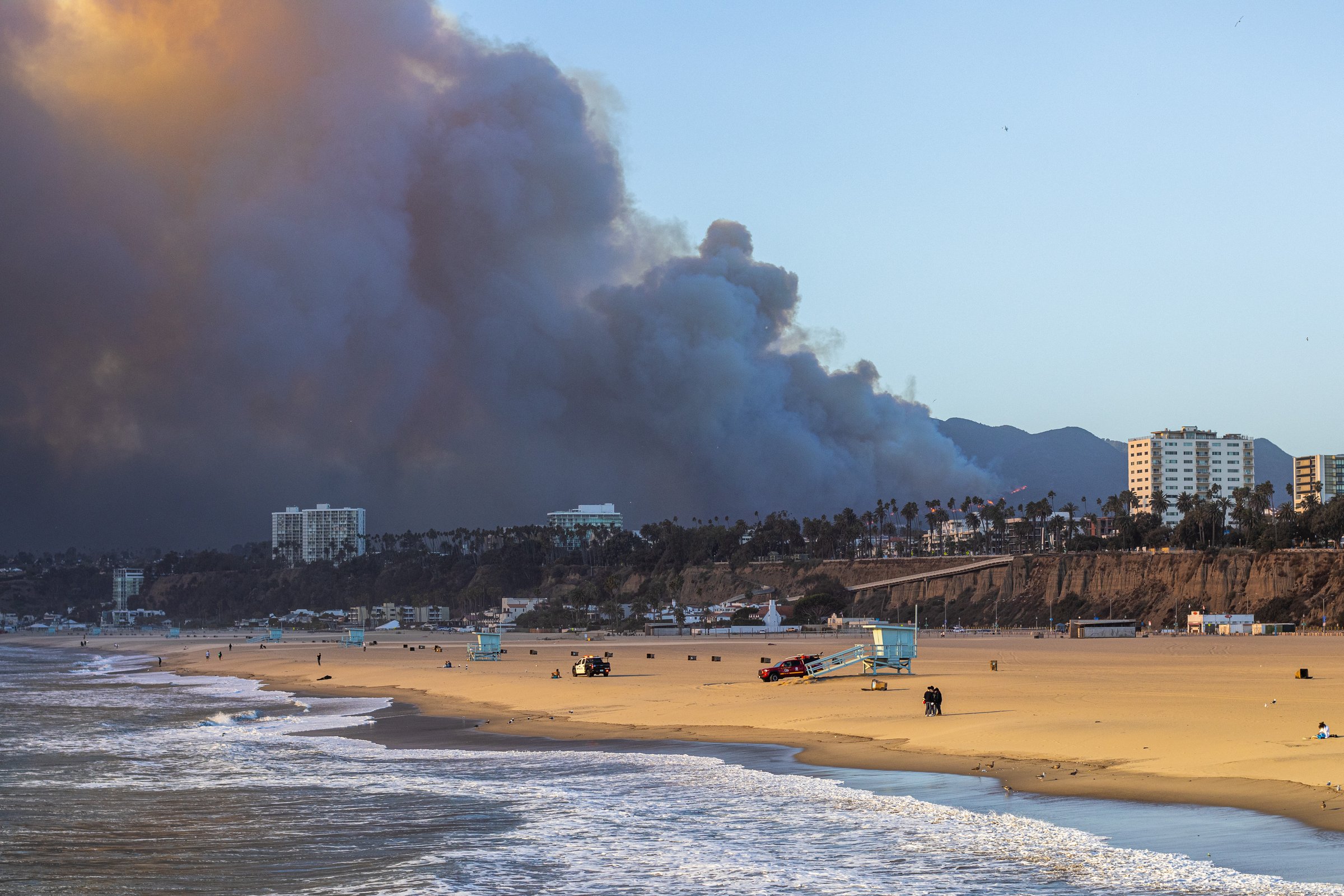 January 7th, 2025, Los Angeles, California. The Pacific Palisades fire burns near Los Angeles, California, with huge plumes of smoke seen from Santa Monica Beach.