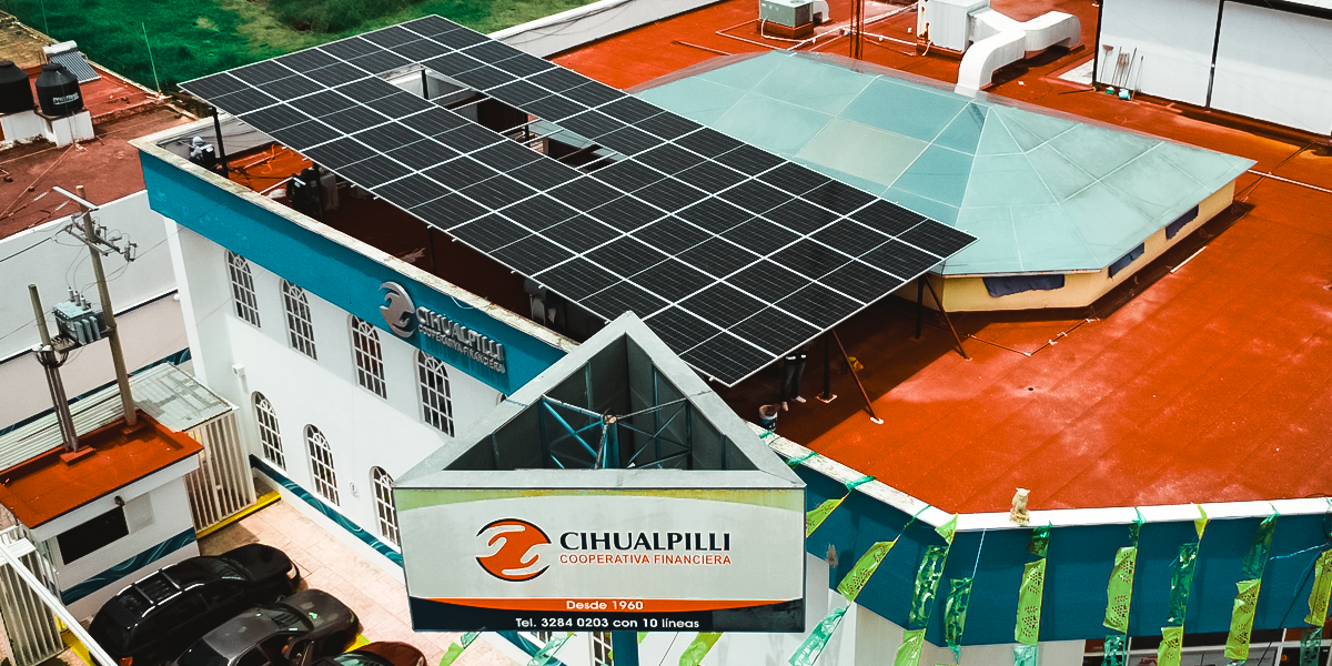 aerial view of community with solar panel installed on apartment building roof