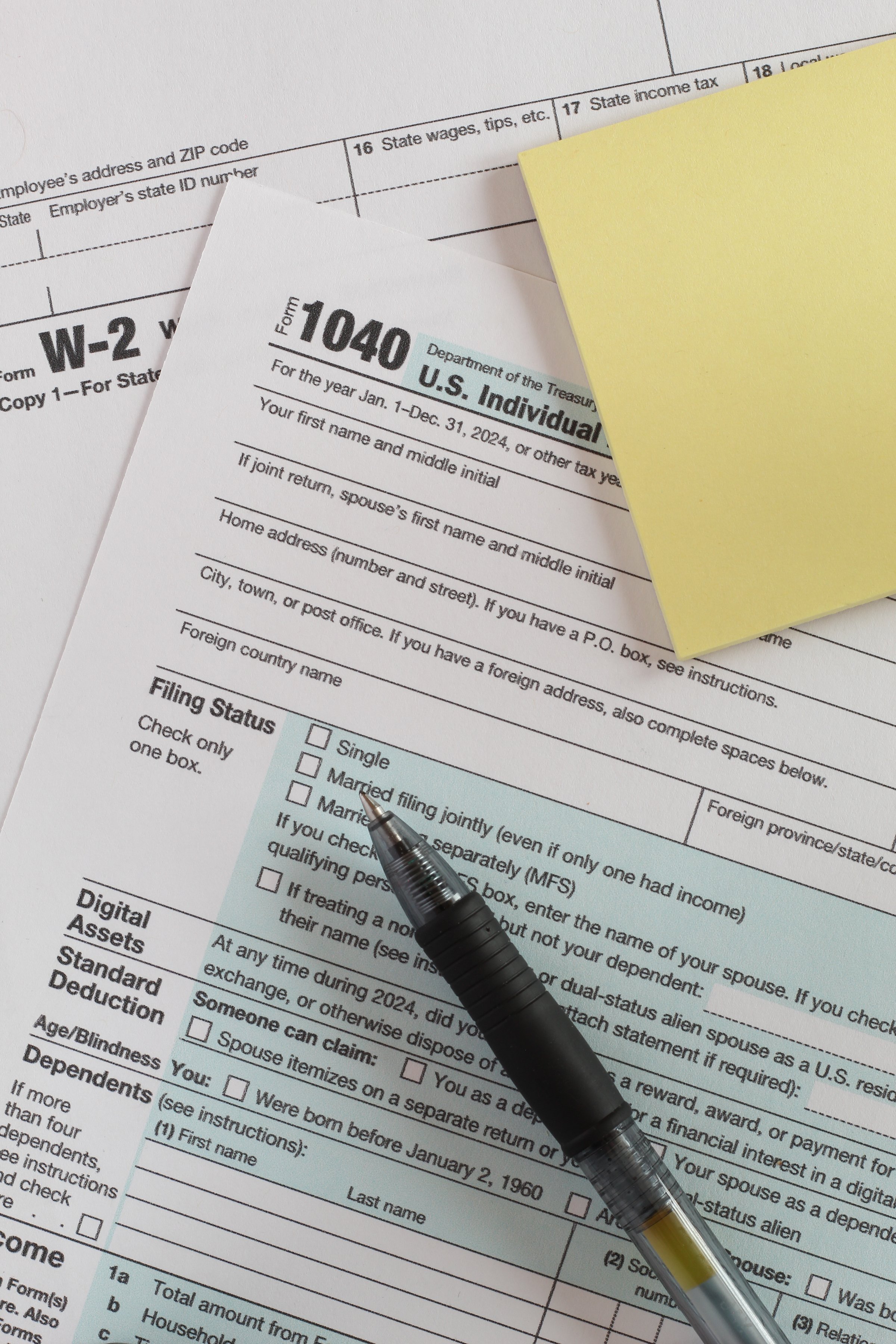 IRS 1040 and W-2 tax forms, close up, top down view