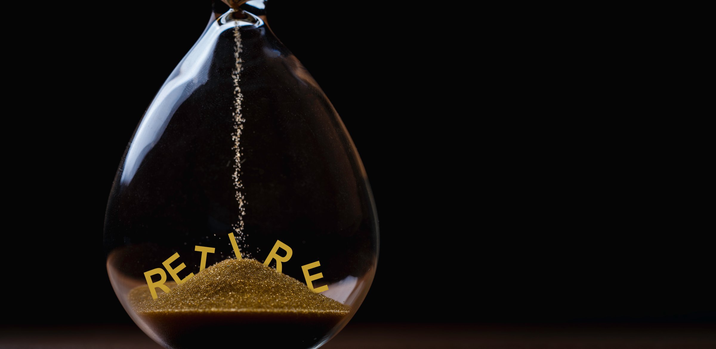 Retire inside of hourglass with sand drops for retirement countdown concept
