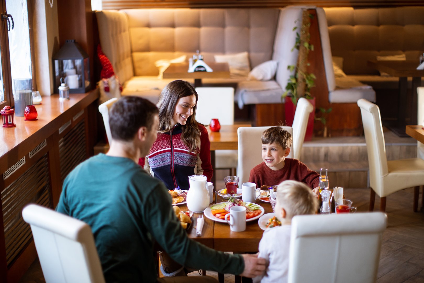 A family sits around a table sharing breakfast