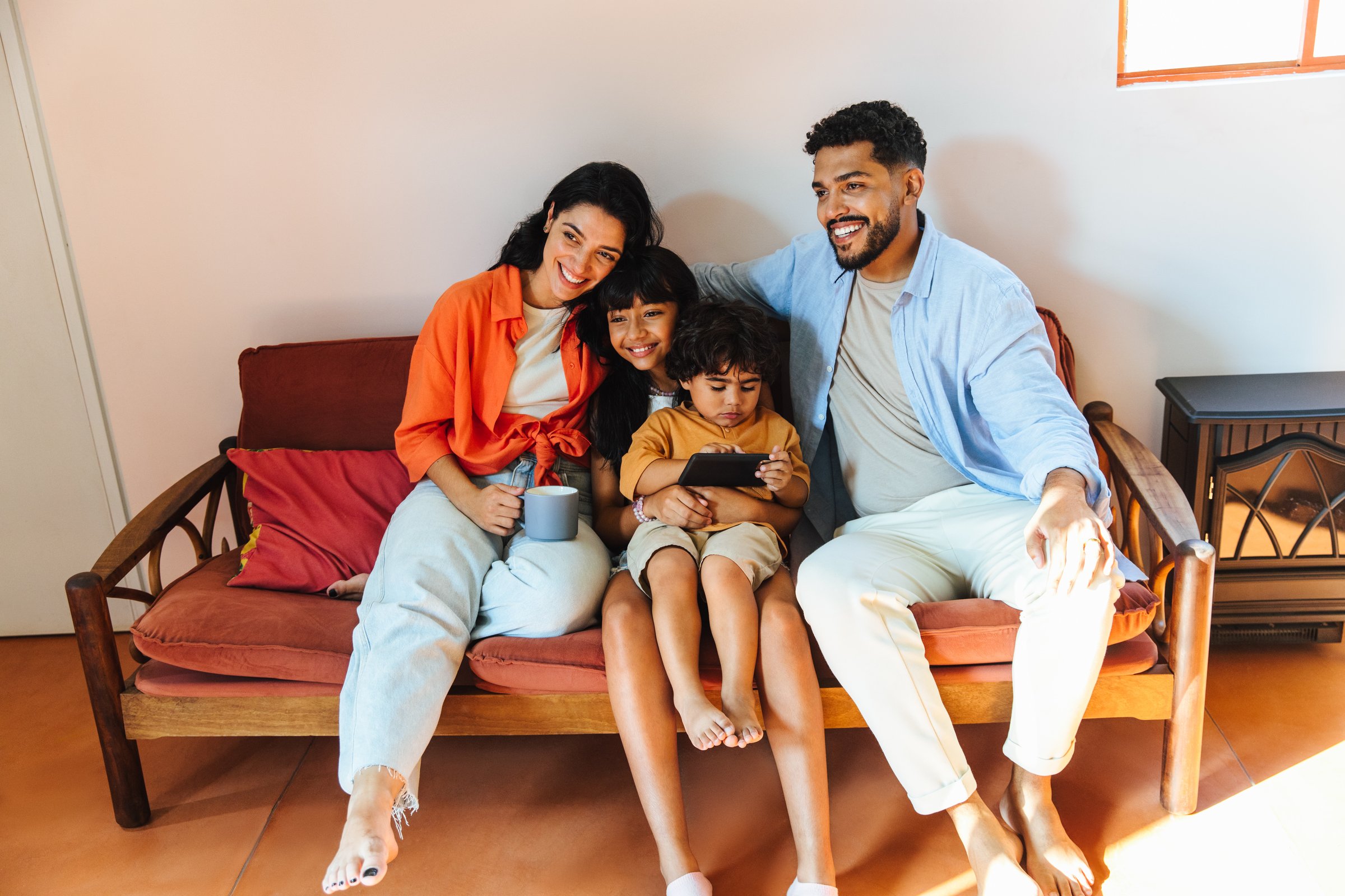 A joyful Latin American family spending quality time together, sharing smiles and warmth at home.