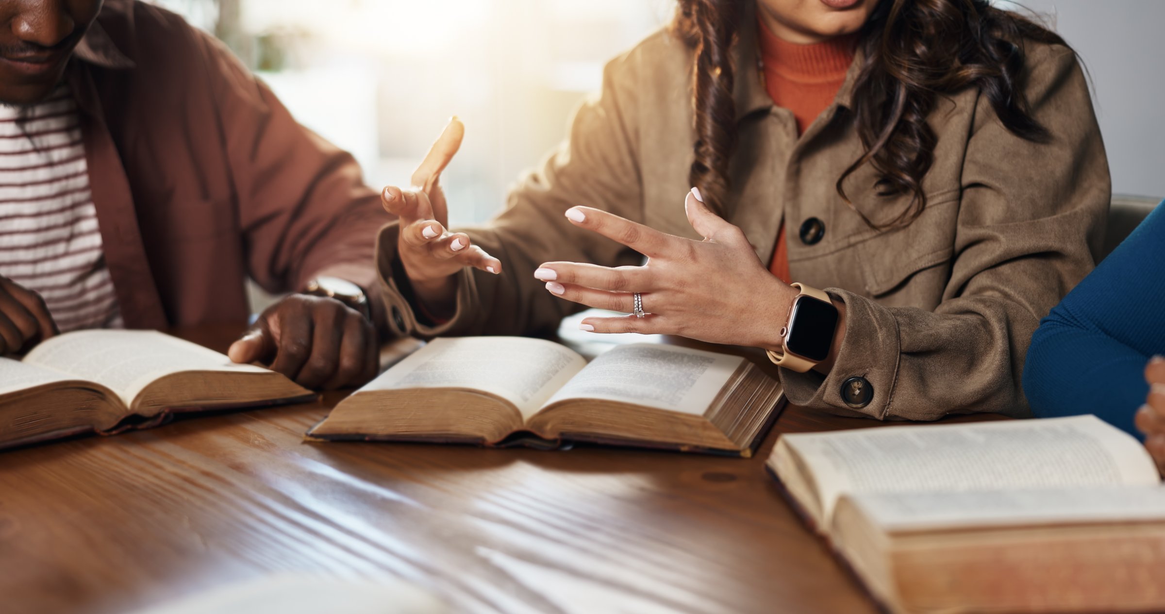 Hands, explain and girl with group for Bible study, worship or learning gospel for religion. Faith, Christianity and knowledge of God, scripture or theology talk for guidance with spiritual growth