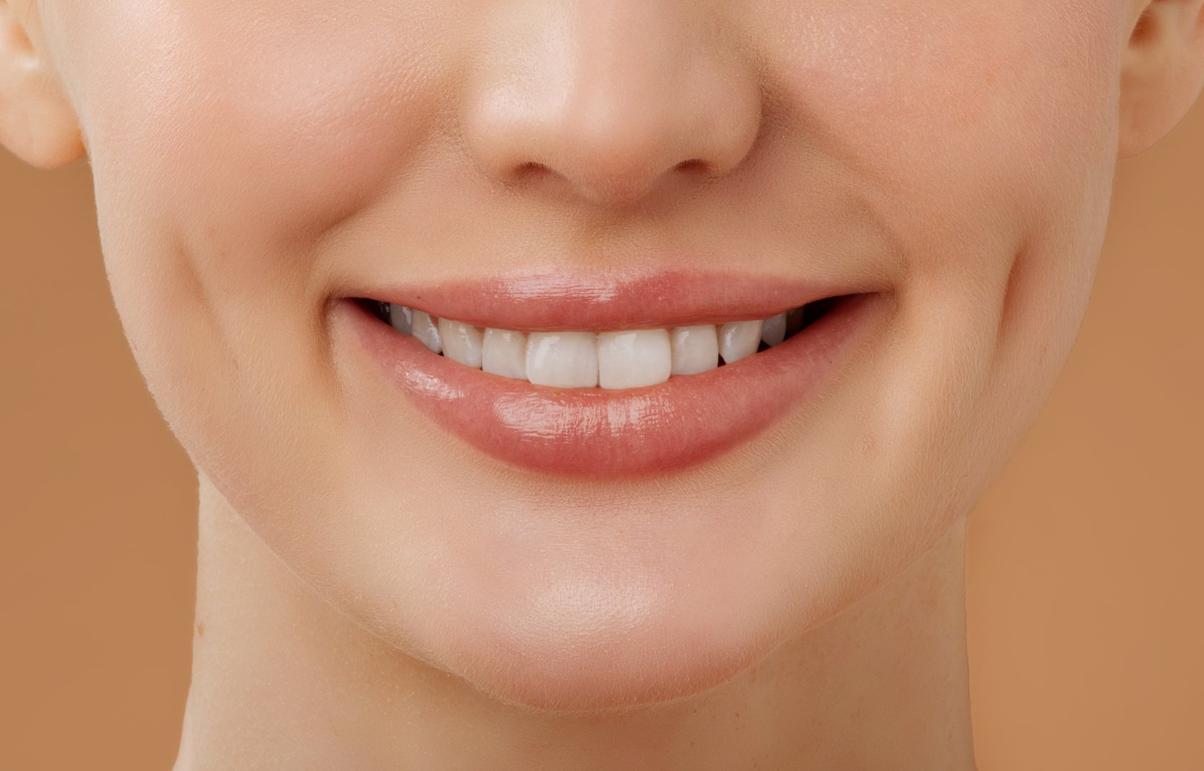 Dental care. Closeup of smiling lady with perfect white teeth, sanding over beige background, cropped shot