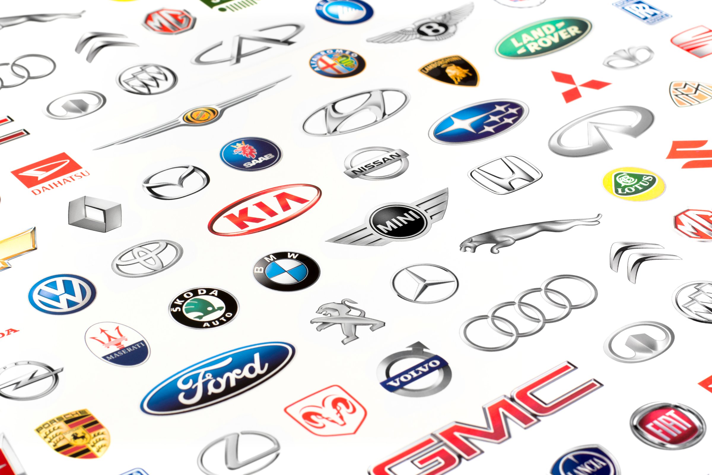 Zaporozhye, Ukraine - June 12, 2015: Photo of a vehicle manufacturer logos printed on paper. Include Mercedes-Benz, Nissan, Kia, Porsche, Audi, BMW, Alfa Romeo, Lexus, Honda, Opel, Land Rover and more others logo.
