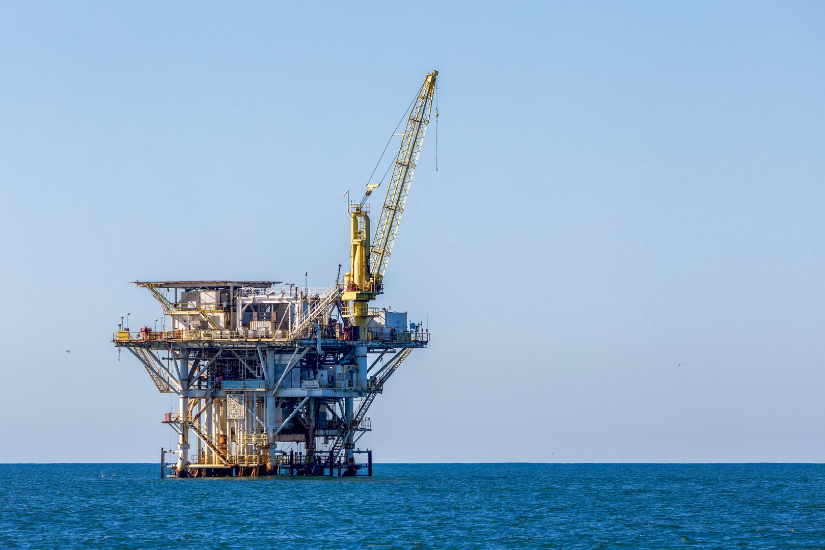 Old abandoned sea rusty drilling platform in the ocean near Channel Islands, California