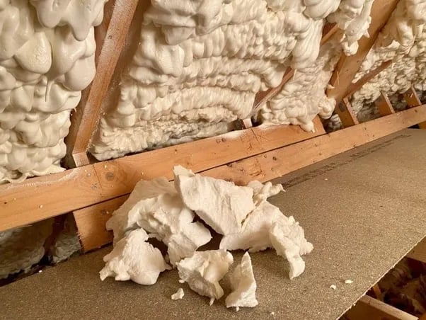 Professional spray foam insulation removal process showing specialized tools and techniques for safe extraction