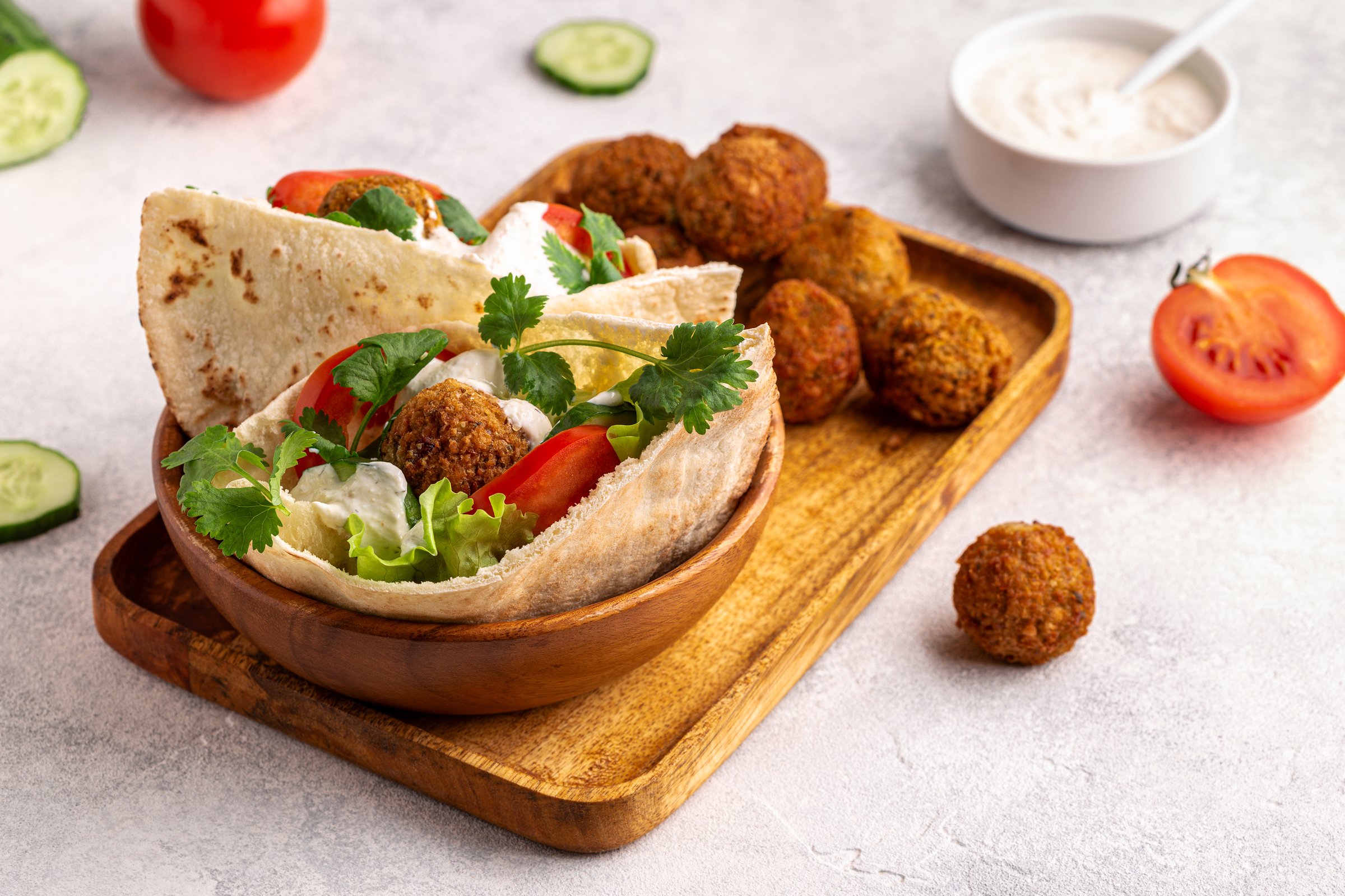 Falafel and fresh vegetables in pita bread.