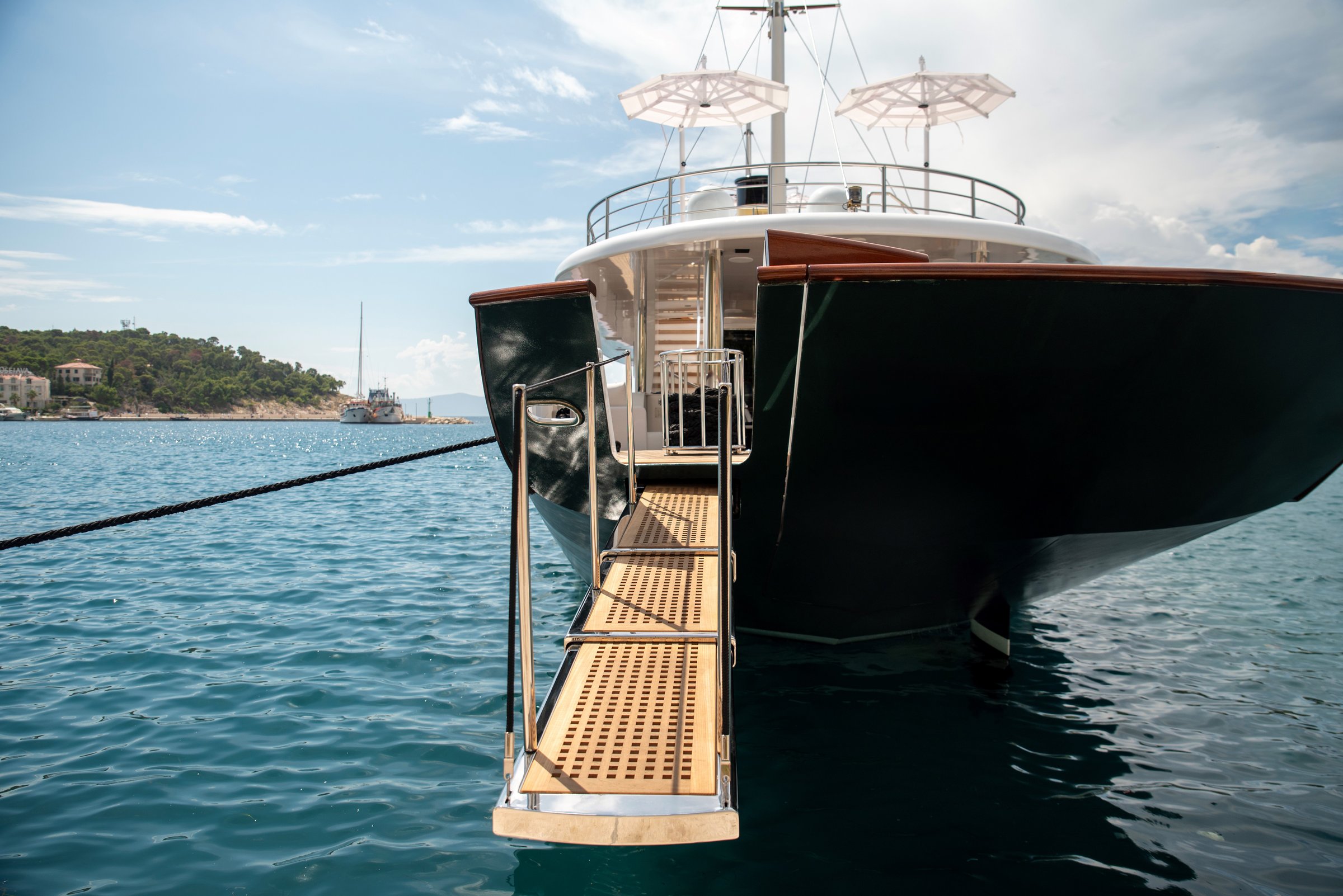 Yacht gangway with metal rail over harbor water