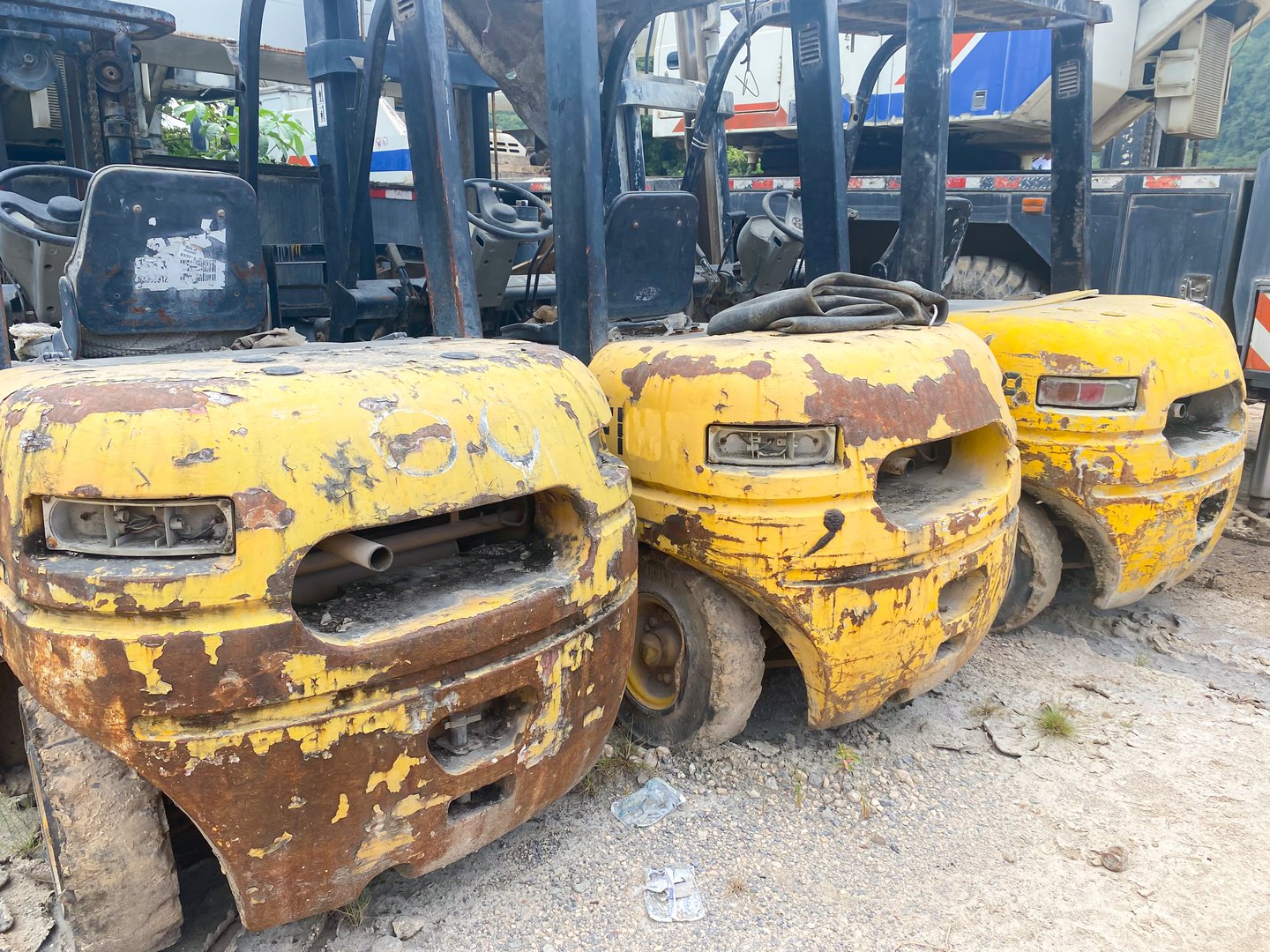 Yellow forklifts parked on gravel