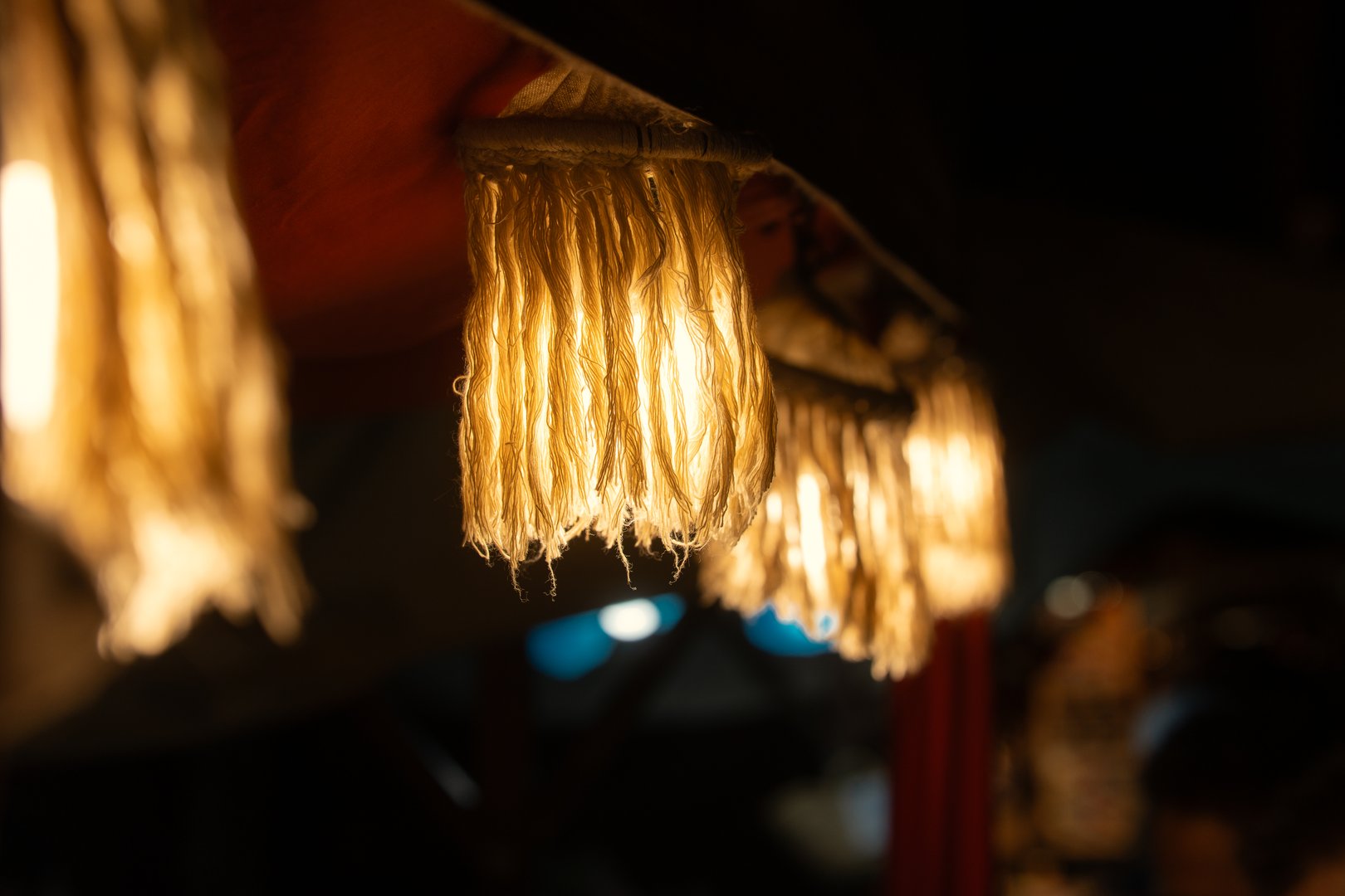 Decorative street market hanging lights of warm yellow tone.