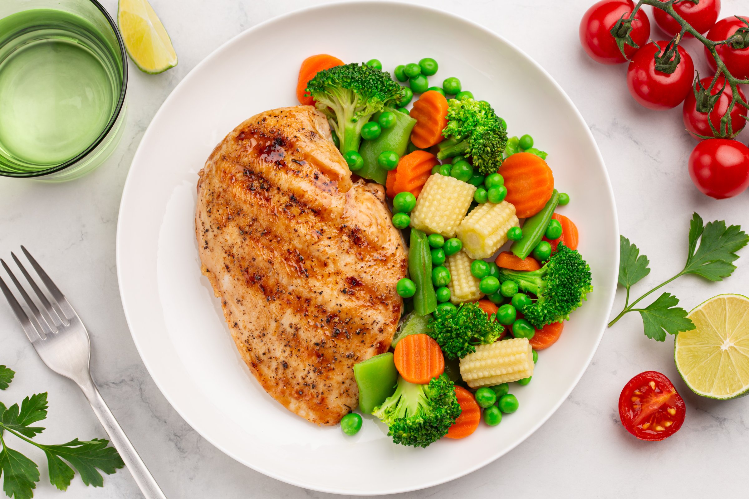 weght loss meal with chicken breast and vegetables, healthy eating and cooking food concept, white background, top view
