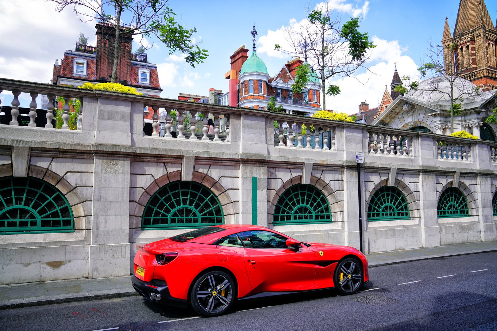 London, England, the United Kingdom, July 18, 2024 – The Ferrari F8 Spider, a high-performance convertible sports car produced by Ferrari. a summer day, building features, street photography.