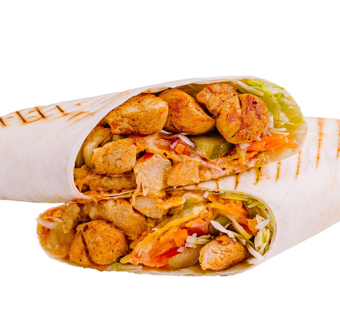 A freshly prepared chicken wrap filled with cooked chicken, vibrant vegetables, and crisp lettuce, presented in a casual dining environment, showcasing its delicious layers and grill marks.