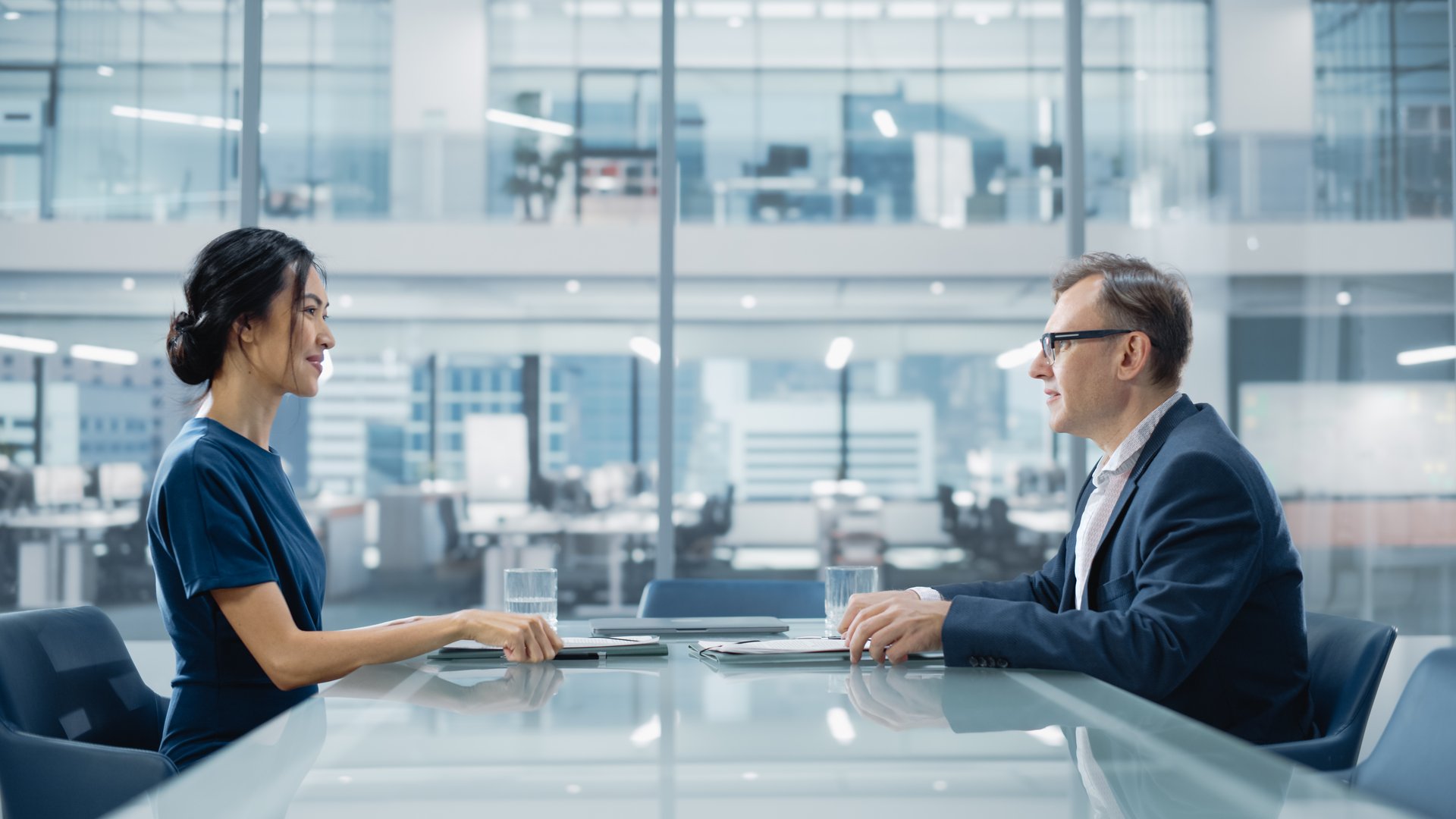Multiethnic Diverse Office Conference Room Meeting: Team of Two Creative Entrepreneurs Talk, Discuss Growth Strategy. Stylish Young Businesspeople work on Digital e-Commerce Startup Project.