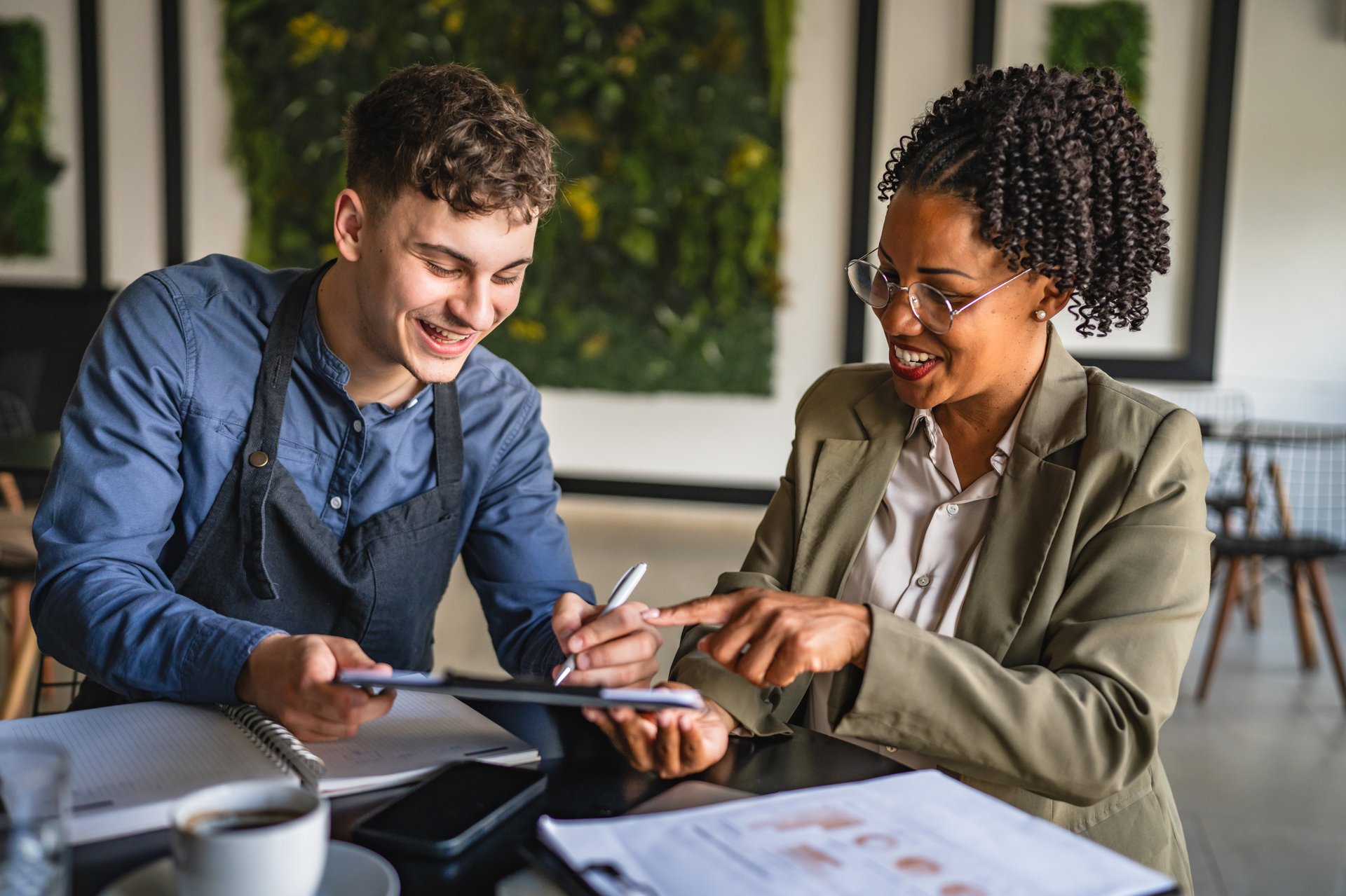 young man entrepreneur sing contract with african american female financial