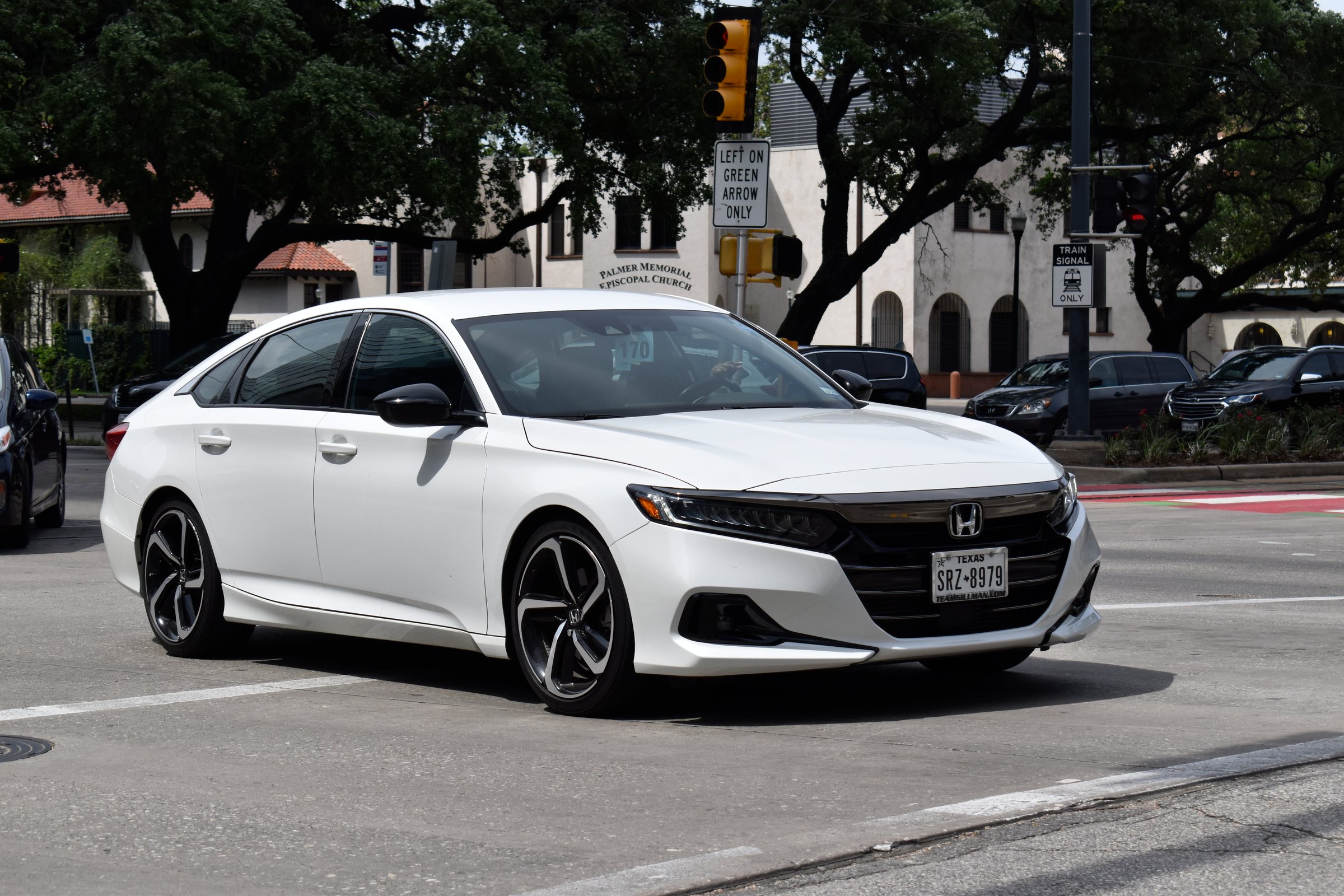 Houston, TX USA - 4-18-2025 - A portrait of a white Honda Accord Hybrid cruising near Hermann Park in Houston.