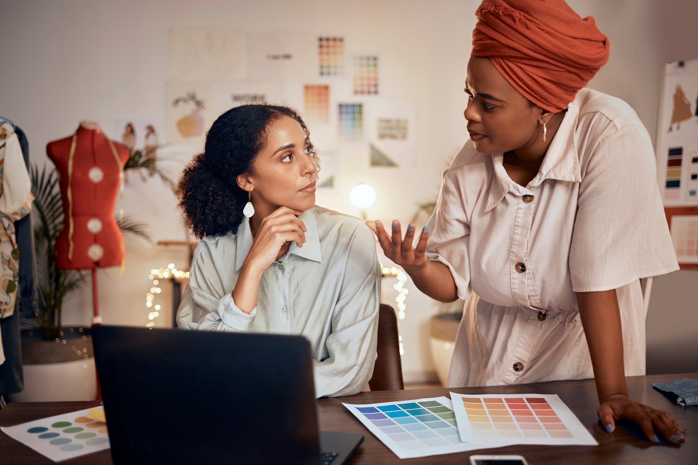 Laptop, meeting or fashion designer women in office planning, collaboration or thinking of creative color wheel. Small business, diversity or startup working for teamwork, analysis or strategy