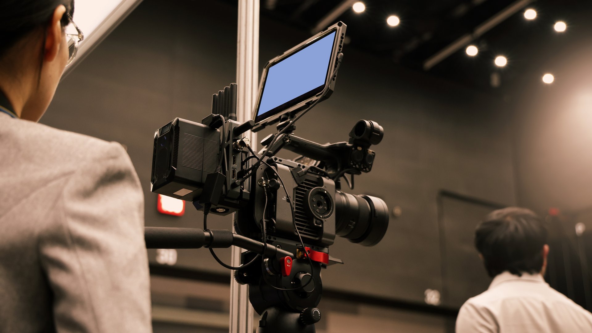 Professional cinema cameras being used in a studio or event setting.  High end gear with crew operation and behind the scenes video production in action. Camera for Live recording and broadcasting.