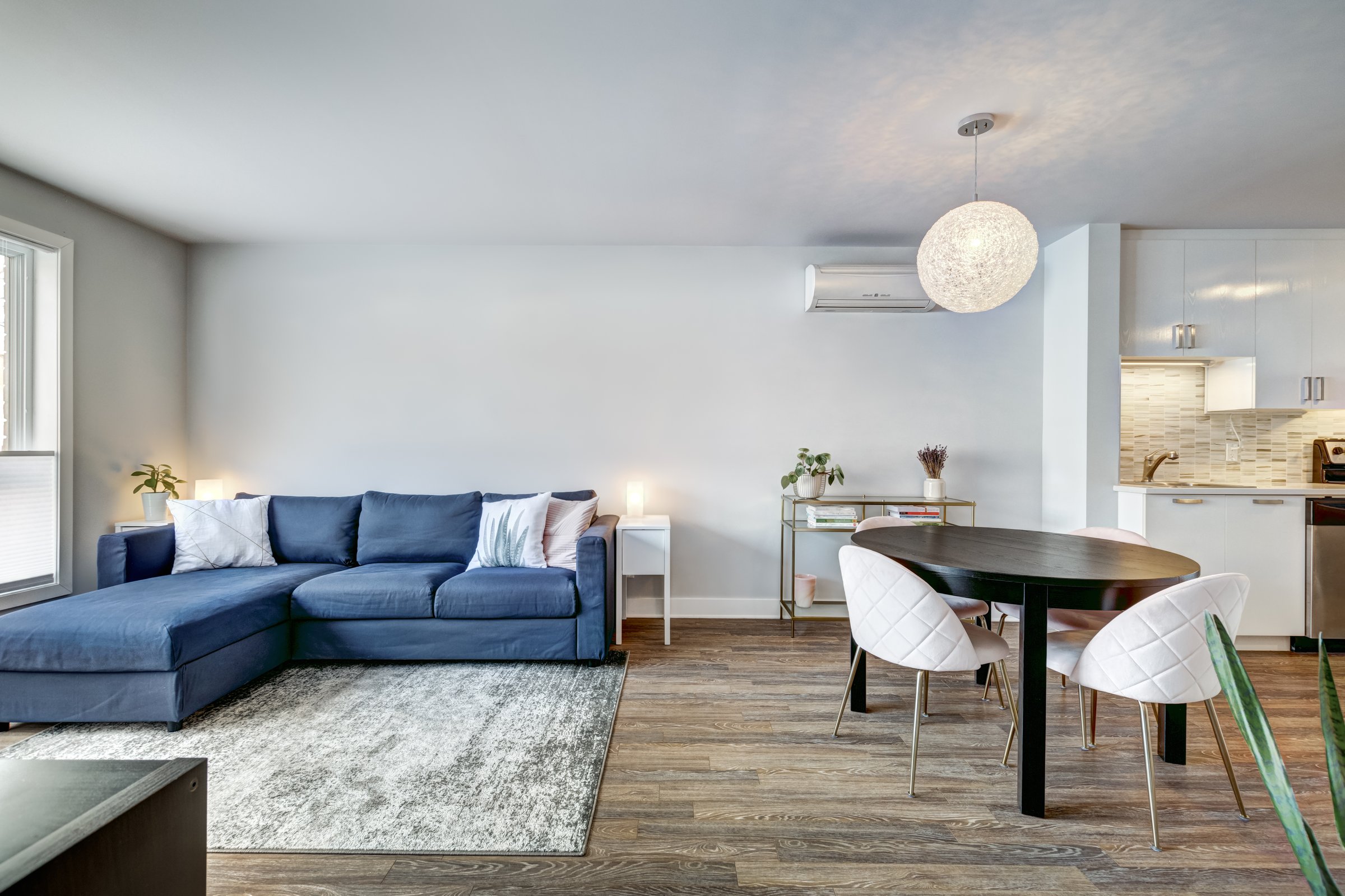 The interior of modern cozy well staged apartment in a building in Montreal including living area, bedrooms, bathroom and terrace